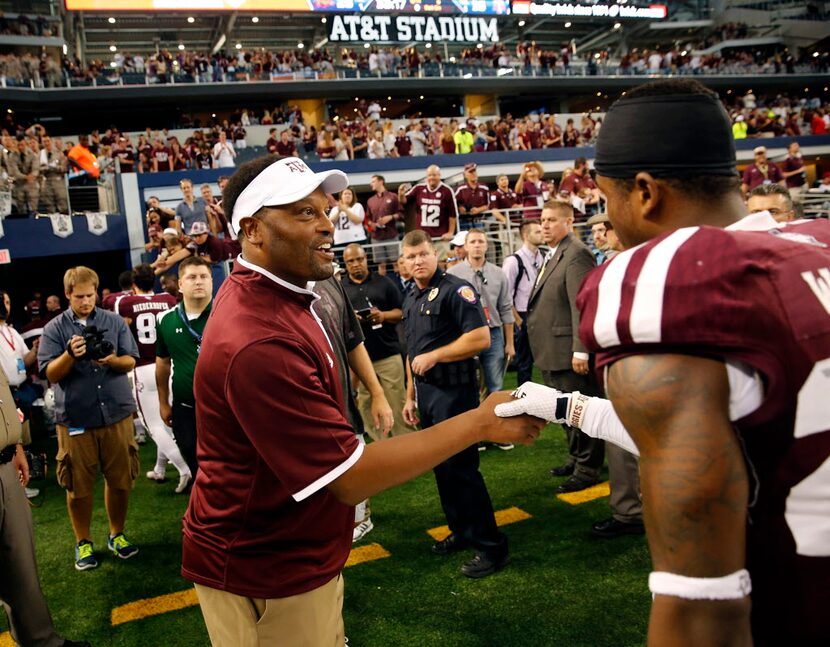 Texas A&M Aggies head coach Kevin Sumlin congratulates defensive back Armani Watts (23) as...