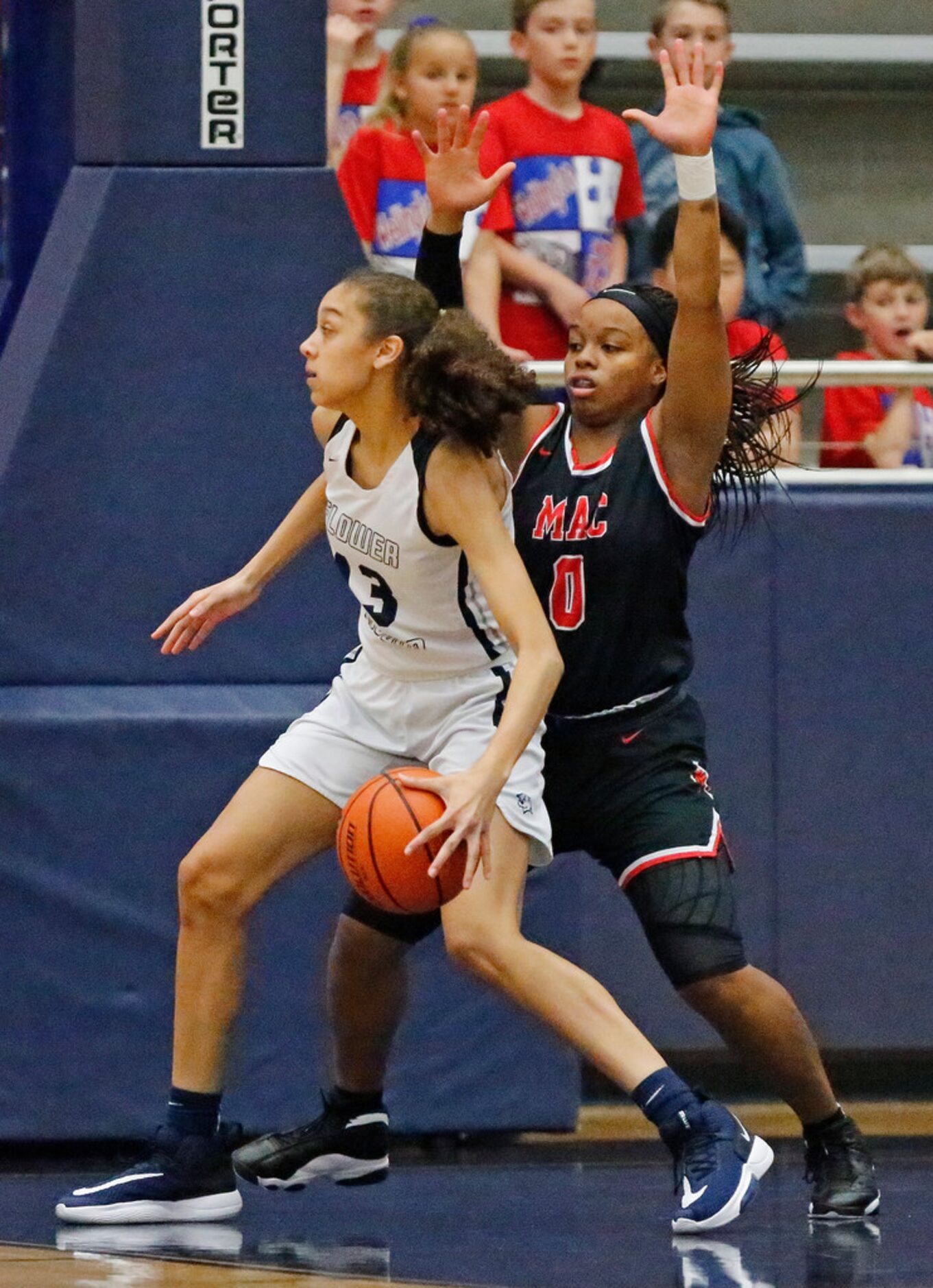 Flower Mound High School forward Sarah Edmondson (13) posts up Irving MacArthur High School...