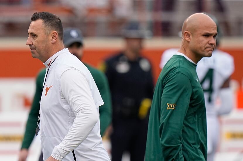 Texas head coach Steve Sarkisian, left, and Baylor head coach Dave Aranda, right, watch...