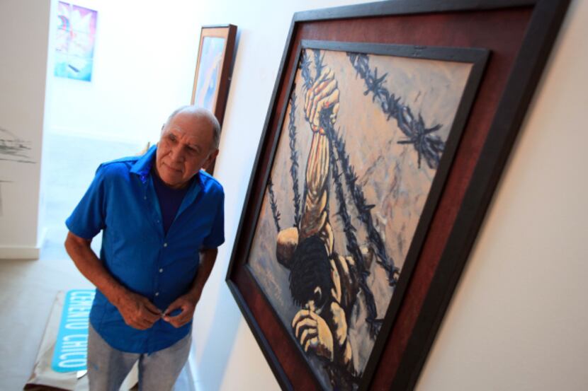 Artist Juan Manuel Campos prepares his work, "The End of the American Dream," for display as...