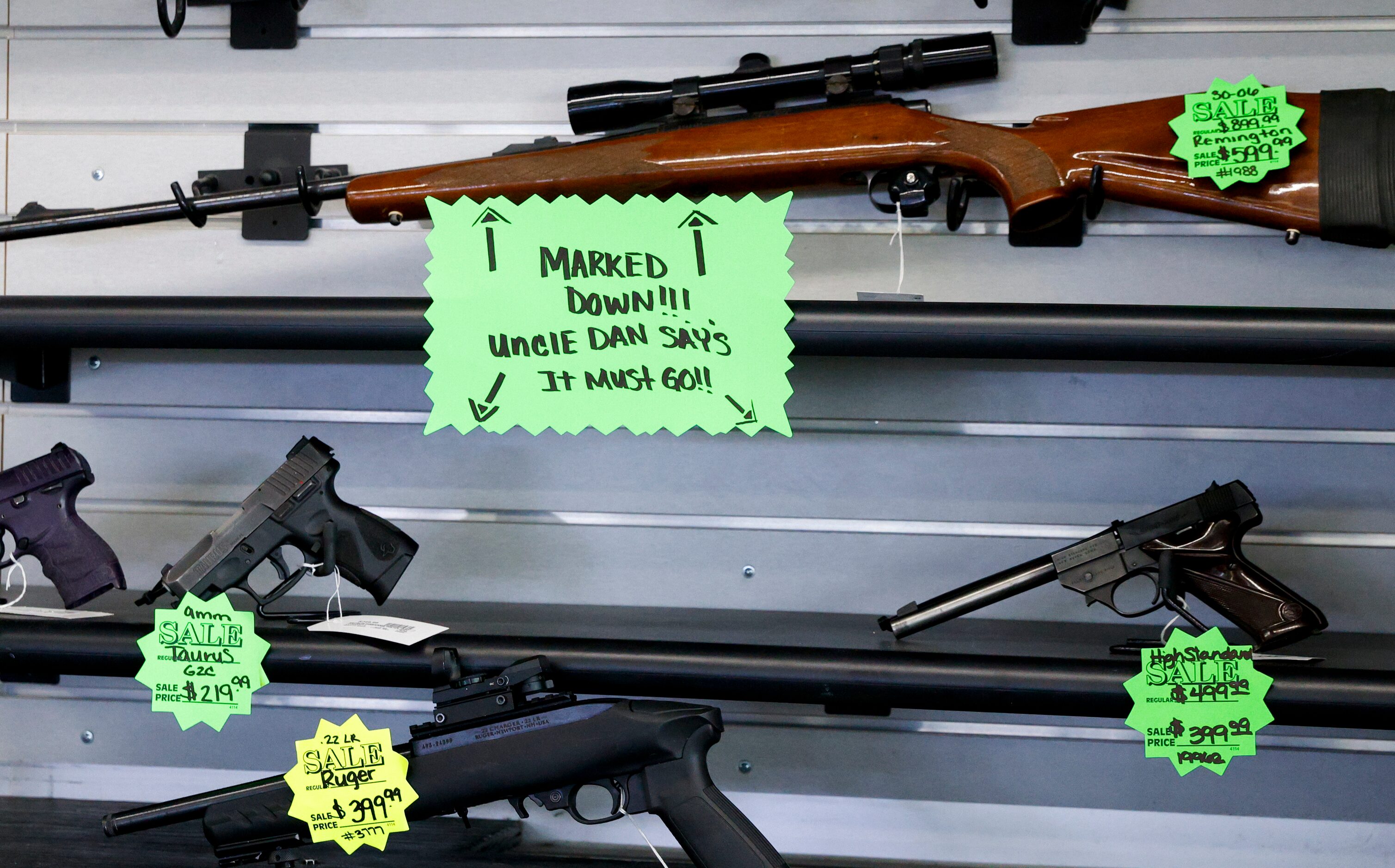 Sale tags show guns for sale as much as $300 off at Uncle Dan’s Pawn Shop in Mesquite,...