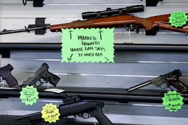 Sale tags show guns for sale as much as $300 off at Uncle Dan’s Pawn Shop in Mesquite,...