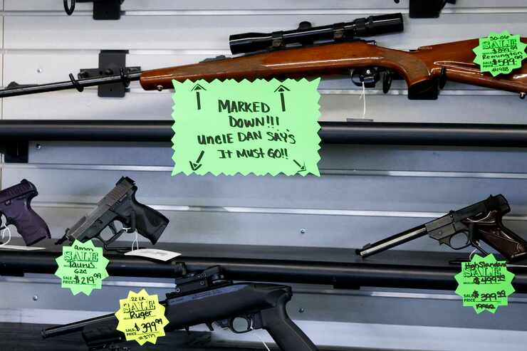 Sale tags show guns for sale as much as $300 off at Uncle Dan’s Pawn Shop in Mesquite,...