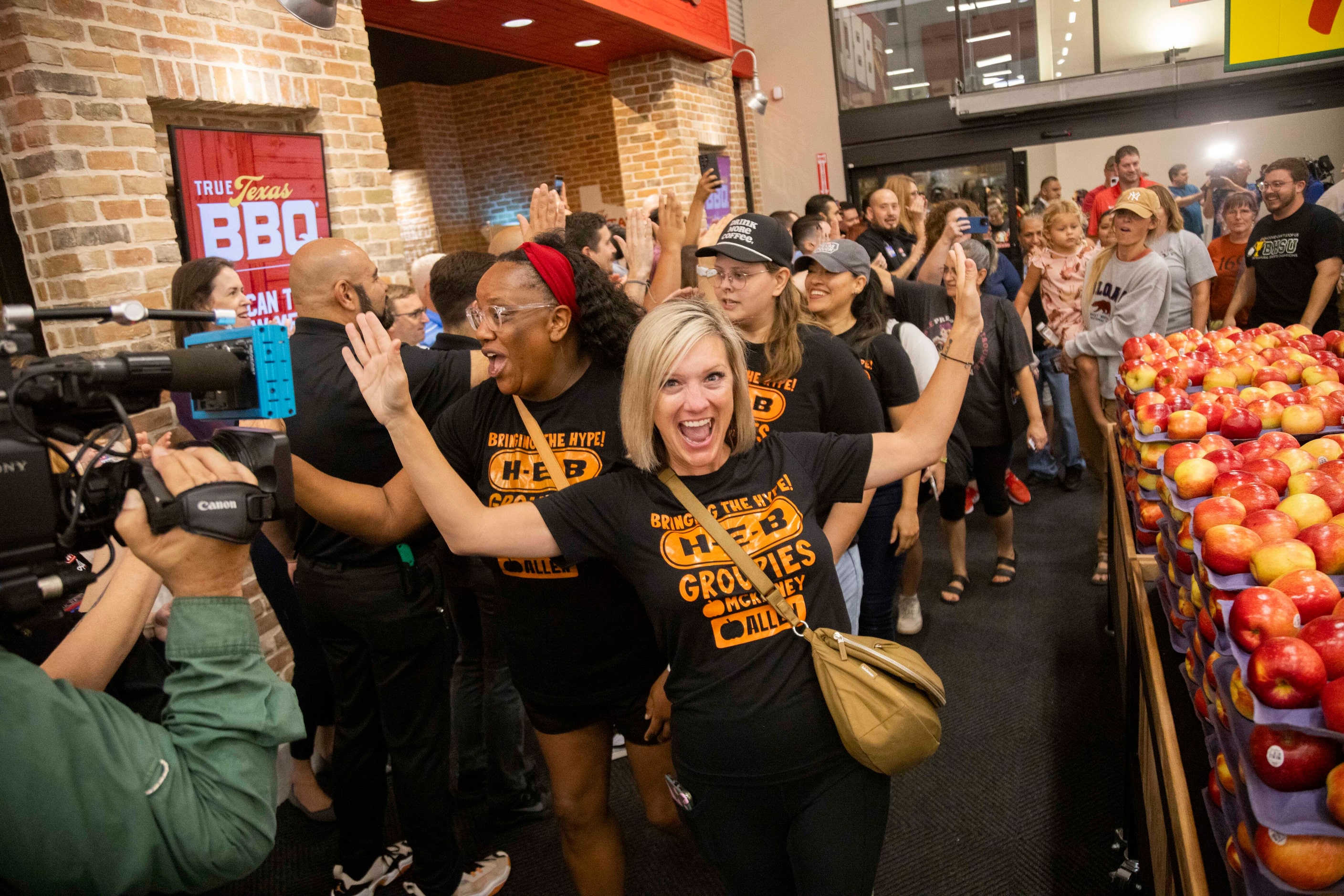 Katie Aldridge (center) of McKinney celebrates being one of the first customers during the...