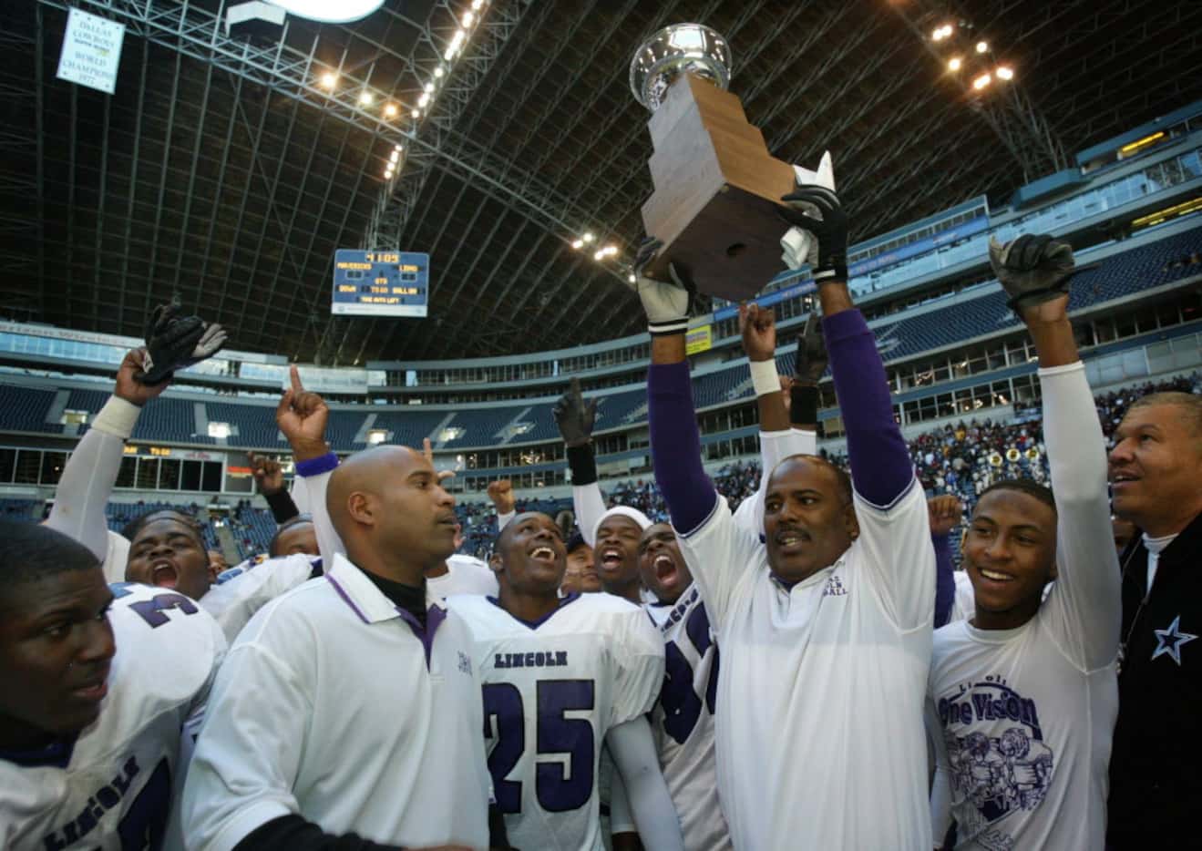  Dallas Lincoln High coach Reginald Samples  (with trophy) and assistants and team members...