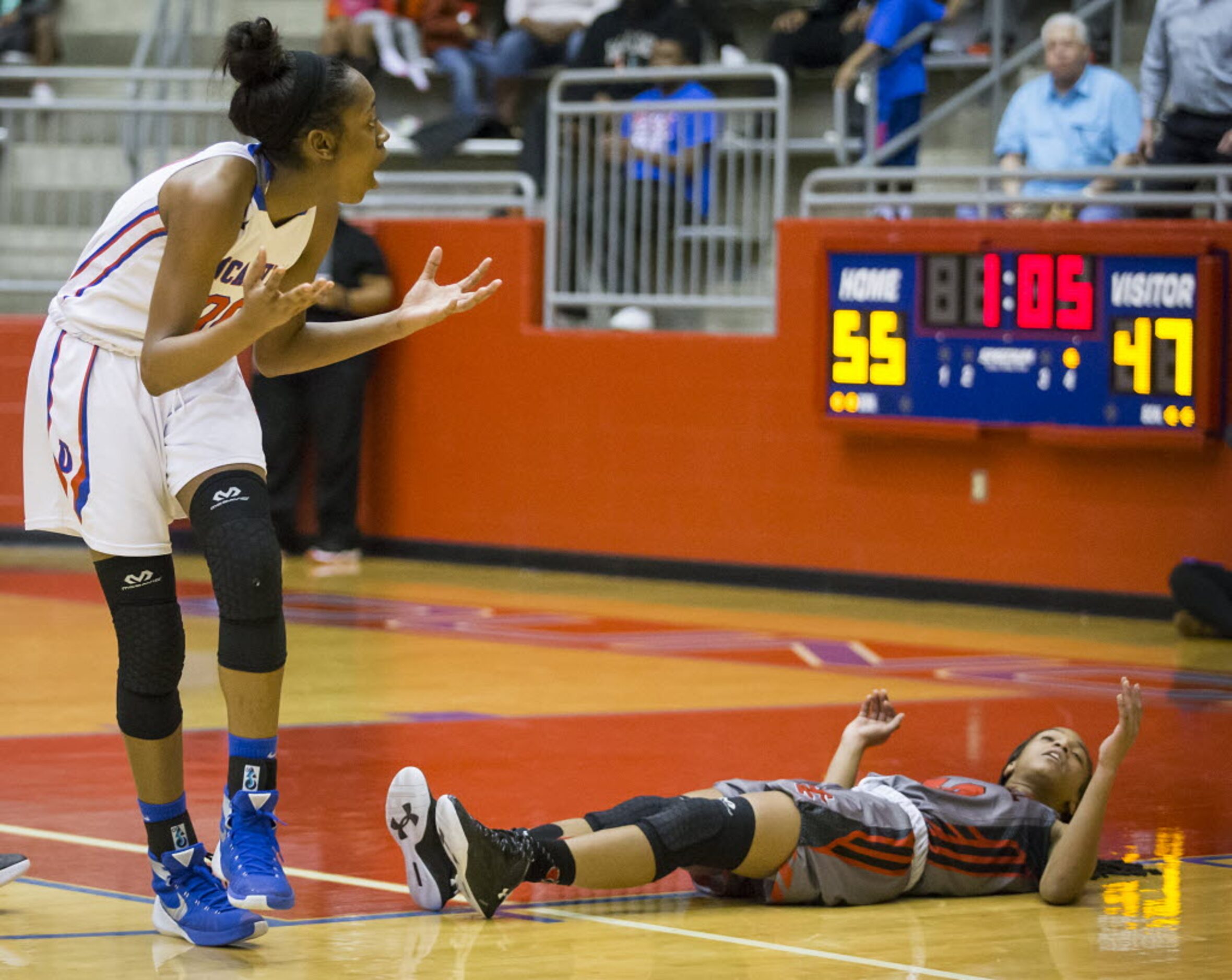 Duncanville forward Zarielle Green (00) reacts after being called for a charging foul after...