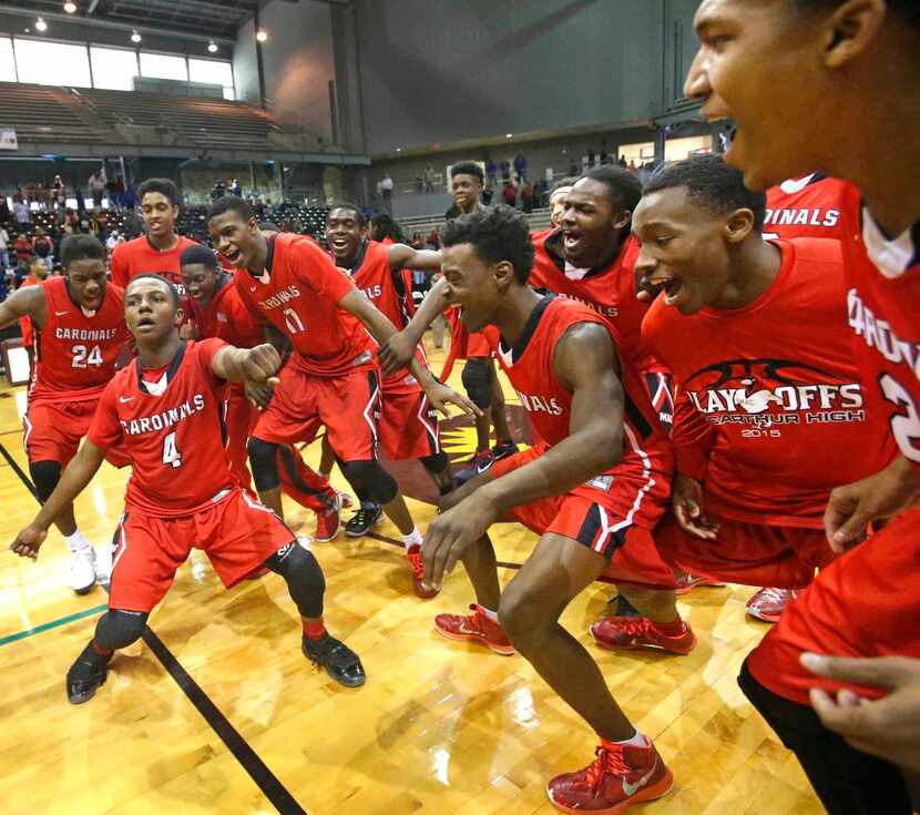 
MacArthur guard Zay Booker (4) leads teammates in the postgame dance at mid-court after the...