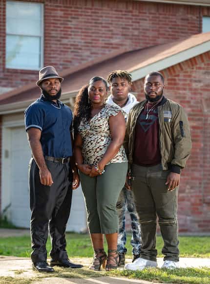 Sammie Anderson (second from left) poses with her sons Sam Bible, 18 (left), Ty Anderson, 15...