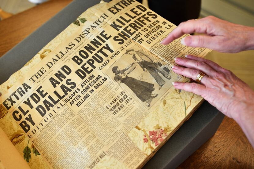 Dallas writer Karen Blumenthal browses a newspaper scrapbook from Sheriff R.A. Smoot Schmid ...