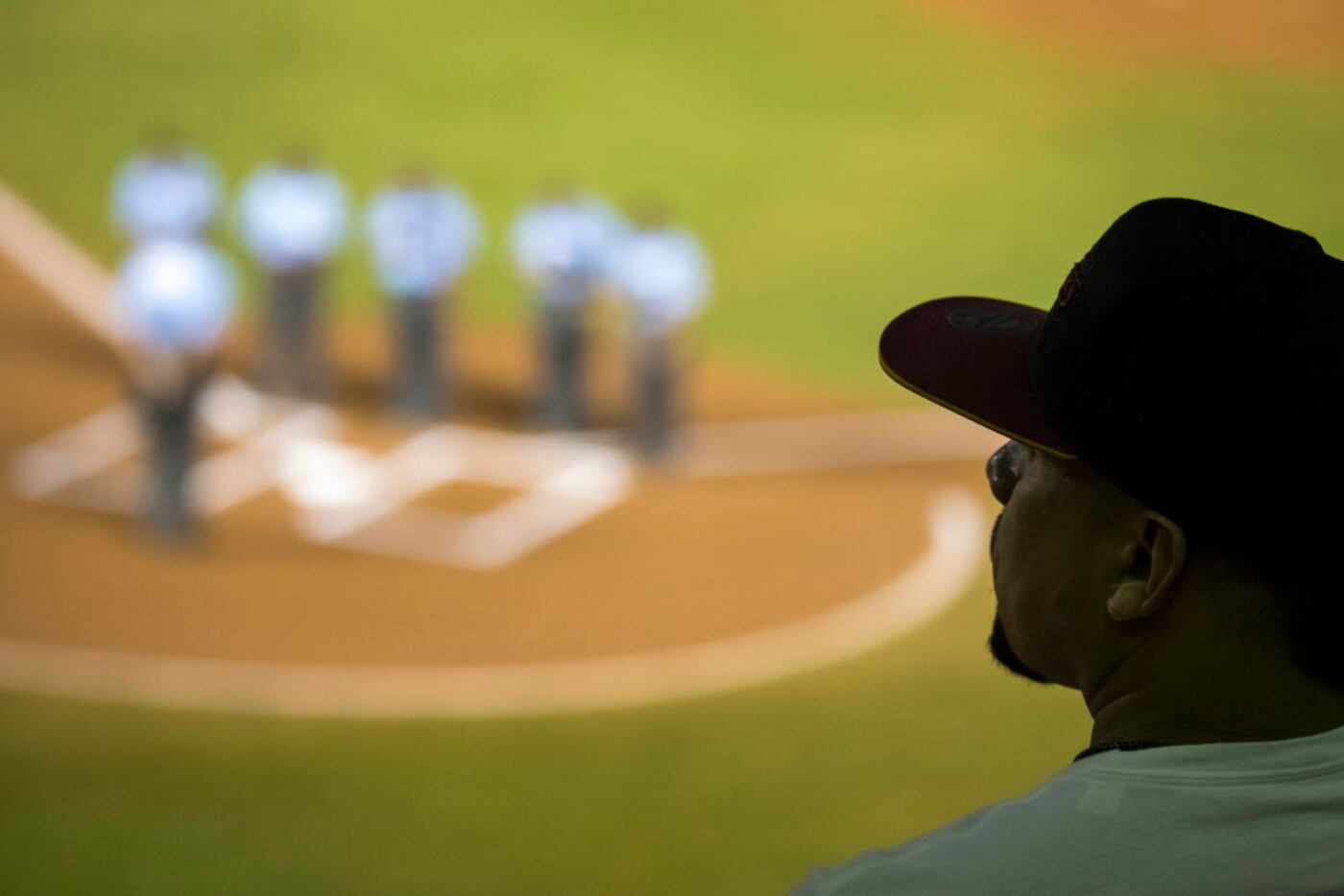 Fans and umpires alike observe a moment of silence before a Puerto Rican Winter League...