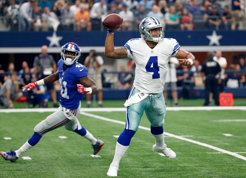 Dallas Cowboys quarterback Dak Prescott (4) throws the ball past New York Giants cornerback...