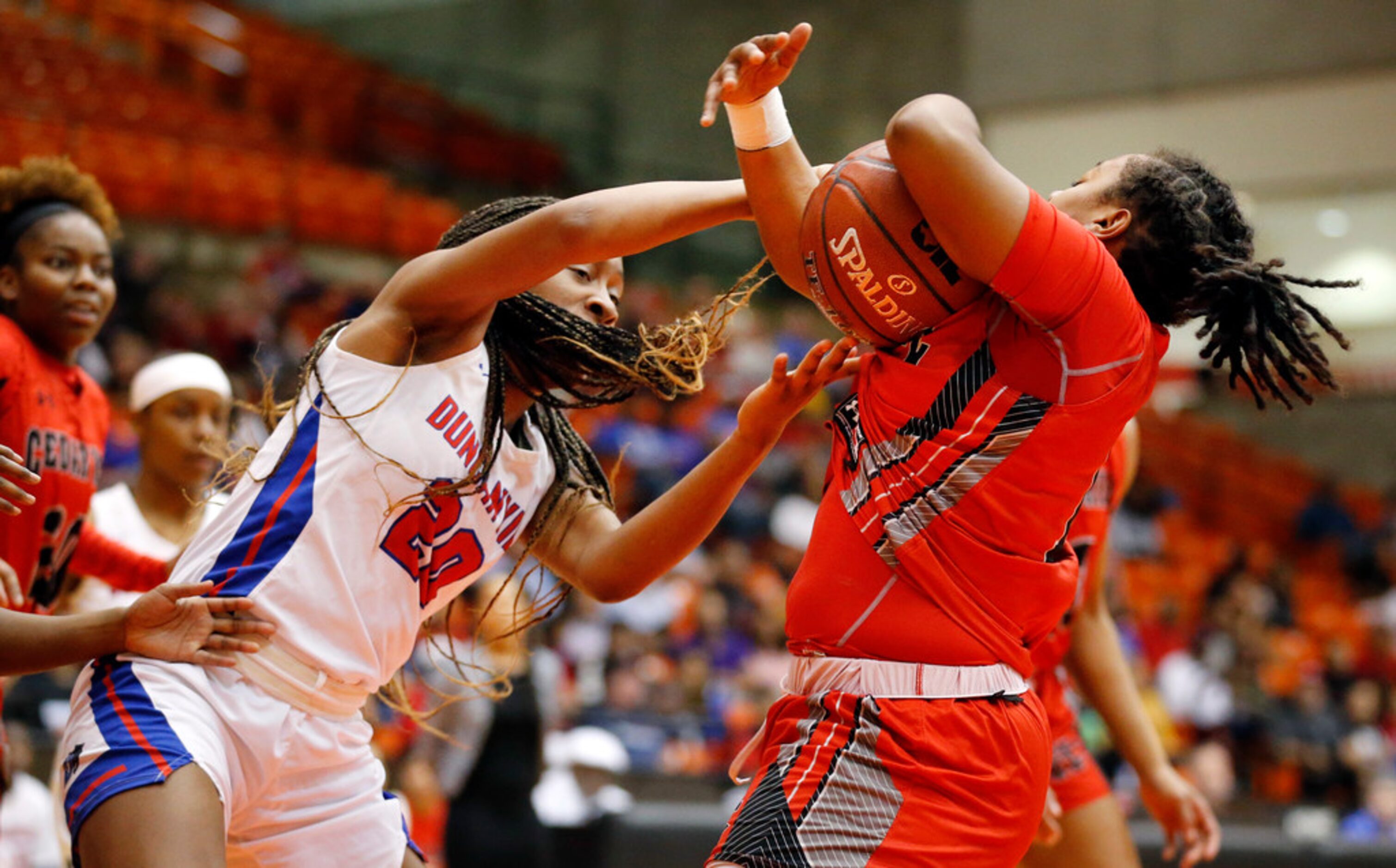 Duncanville's Anaya Bernard (20) tries to grab an offensive rebound from Cedar Hills' Portia...