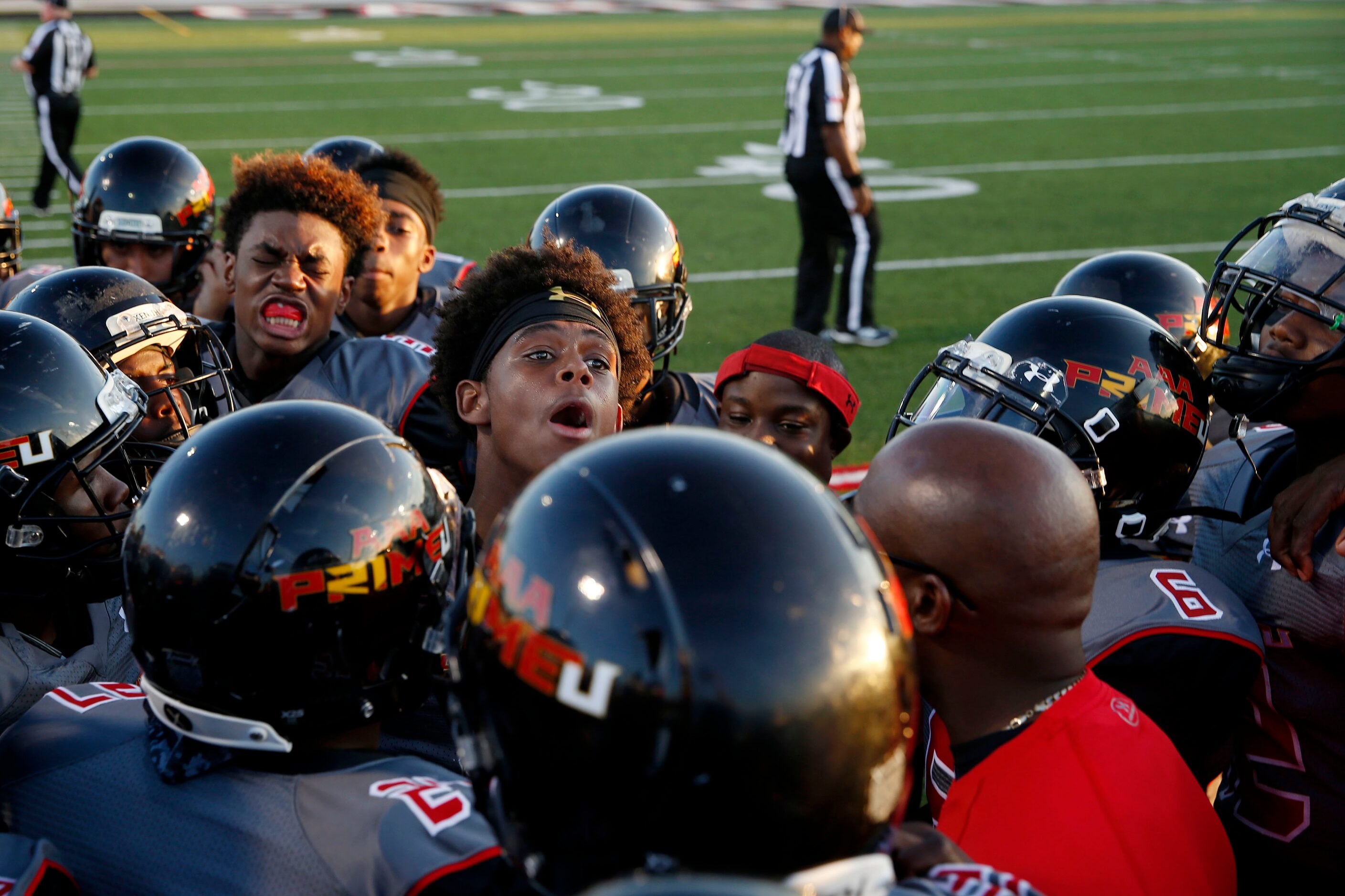 AAA Prime U players prepare for kickoff before a high school football game between AAA Prime...