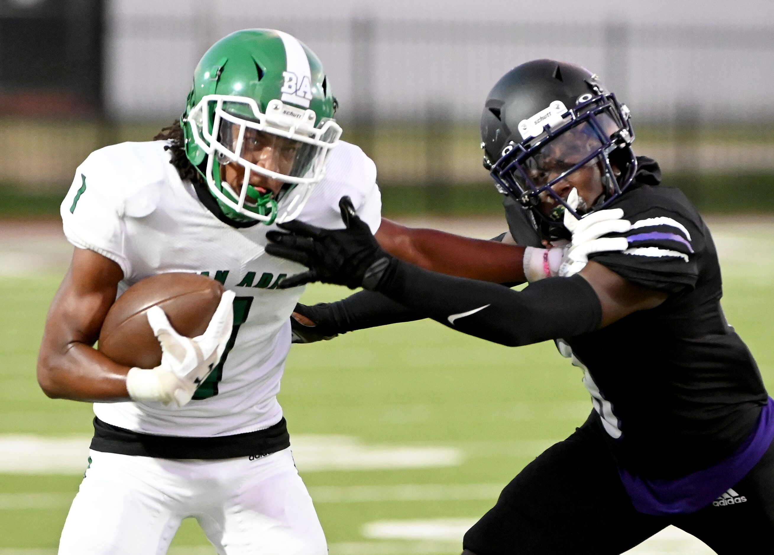 Bryan Adam’s Rishon Taylor (1) stiff arms Lincoln’s Donnell Williams (8) in the first half...