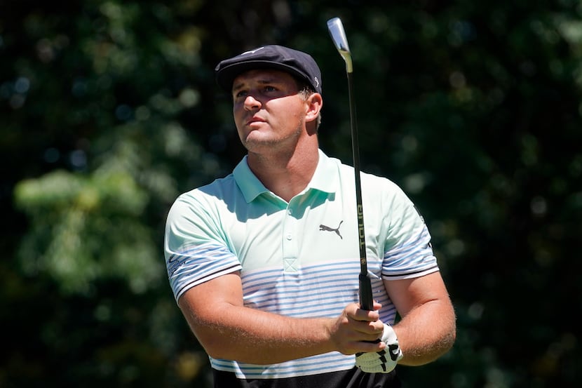 PGA Tour golfer Bryson DeChambeau watches his tee shot on No. 9 during the opening round of...