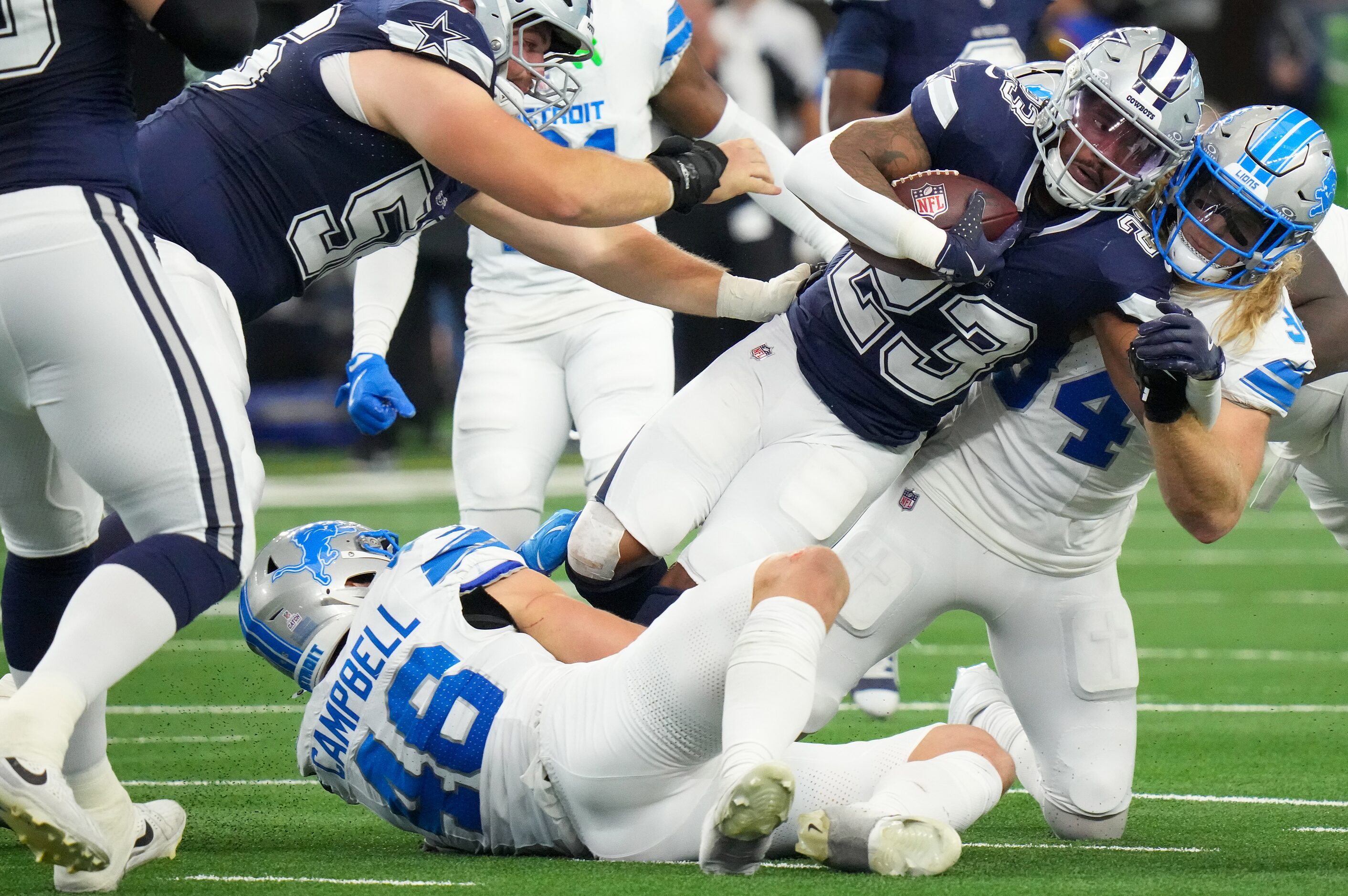 Dallas Cowboys running back Rico Dowdle (23) is brought down by Detroit Lions linebackers...