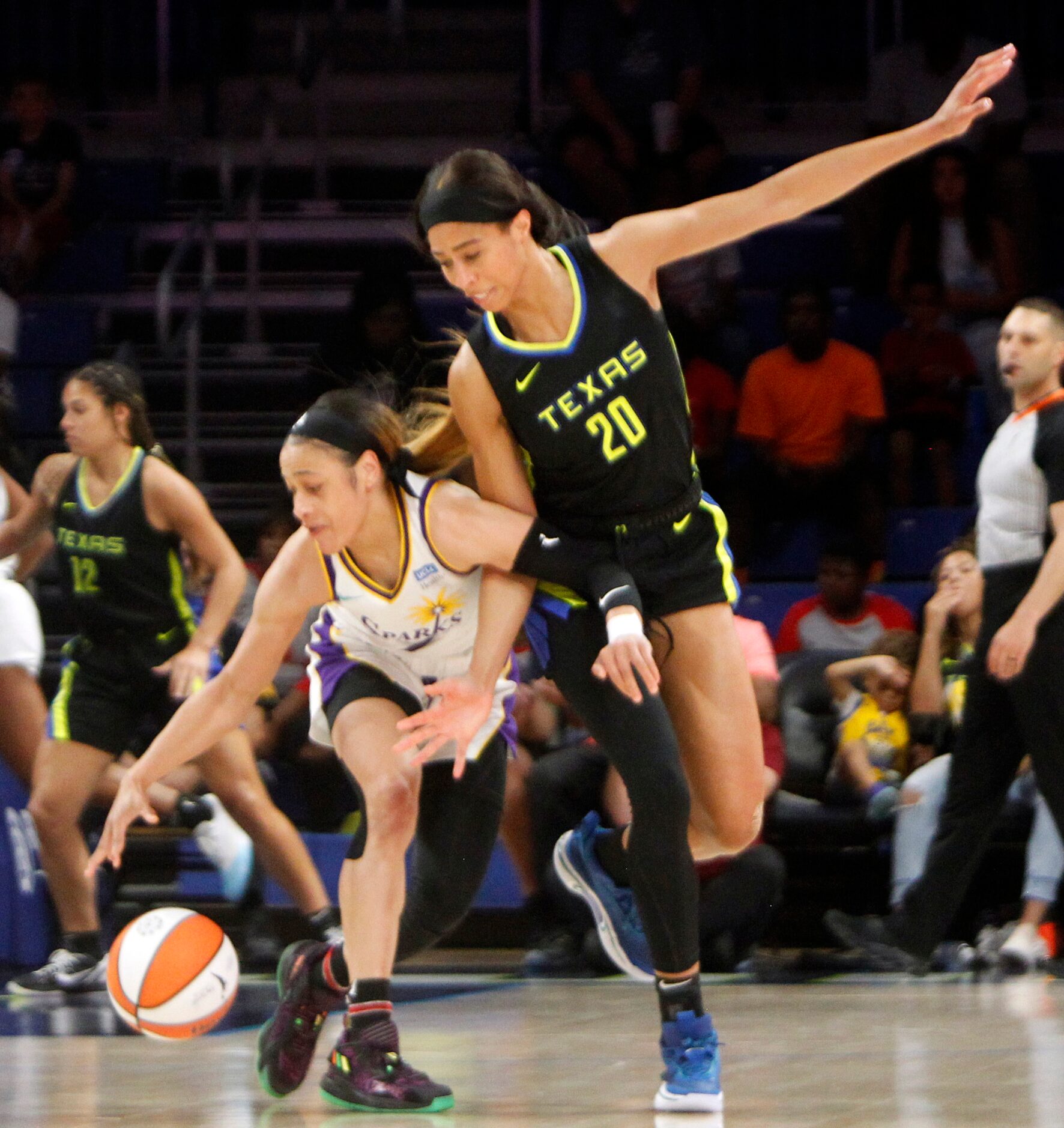 Dallas Wings forward Isabelle Harrison (20) defends against LA Sparks guard Chennedy Carter...