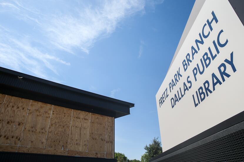 Boarded up windows, broken by storms in June, are seen at the Fretz Park branch of the...