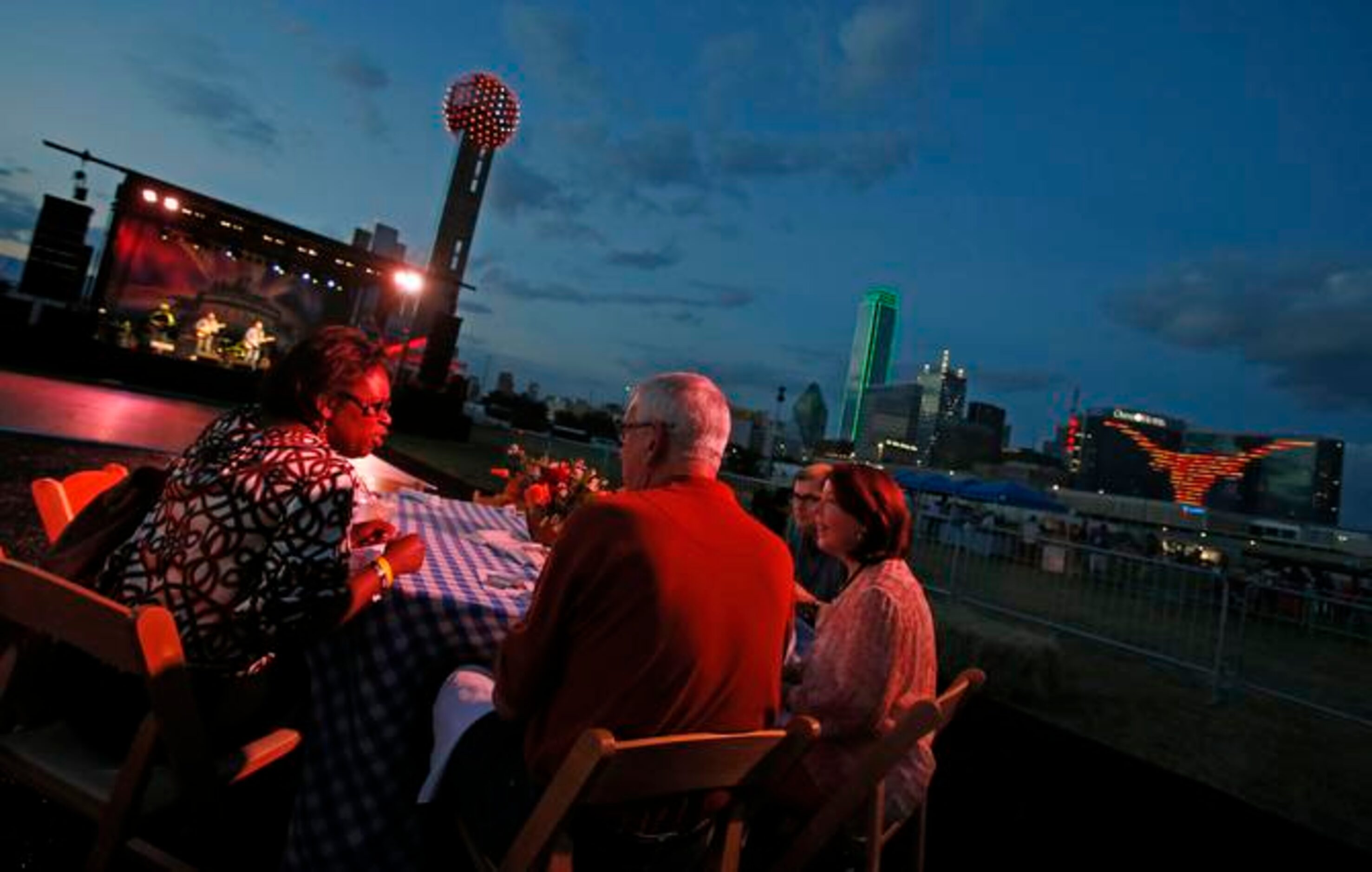 
Diners enjoy dinner at dusk as part of the "Celebrate Texas-OU Weekend" activities at the...