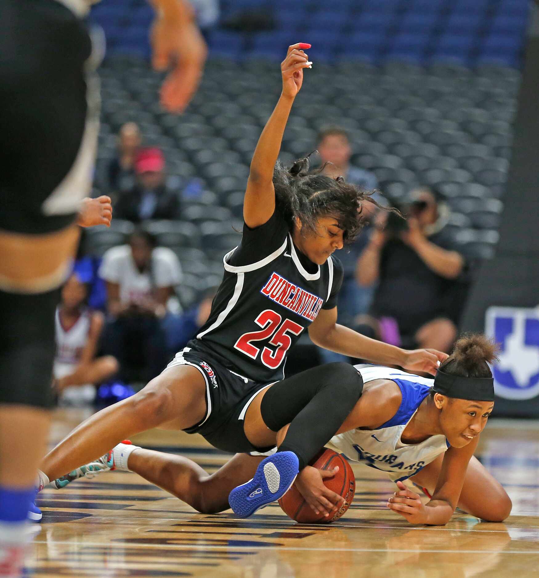 Duncanville guard Deja Kelly #25 fights for a lose ball  with Cypress Creek guard Krishawn...