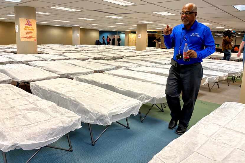 Winford Cross, Homeless Services Supervisor for the City of Dallas, counts cots at the...
