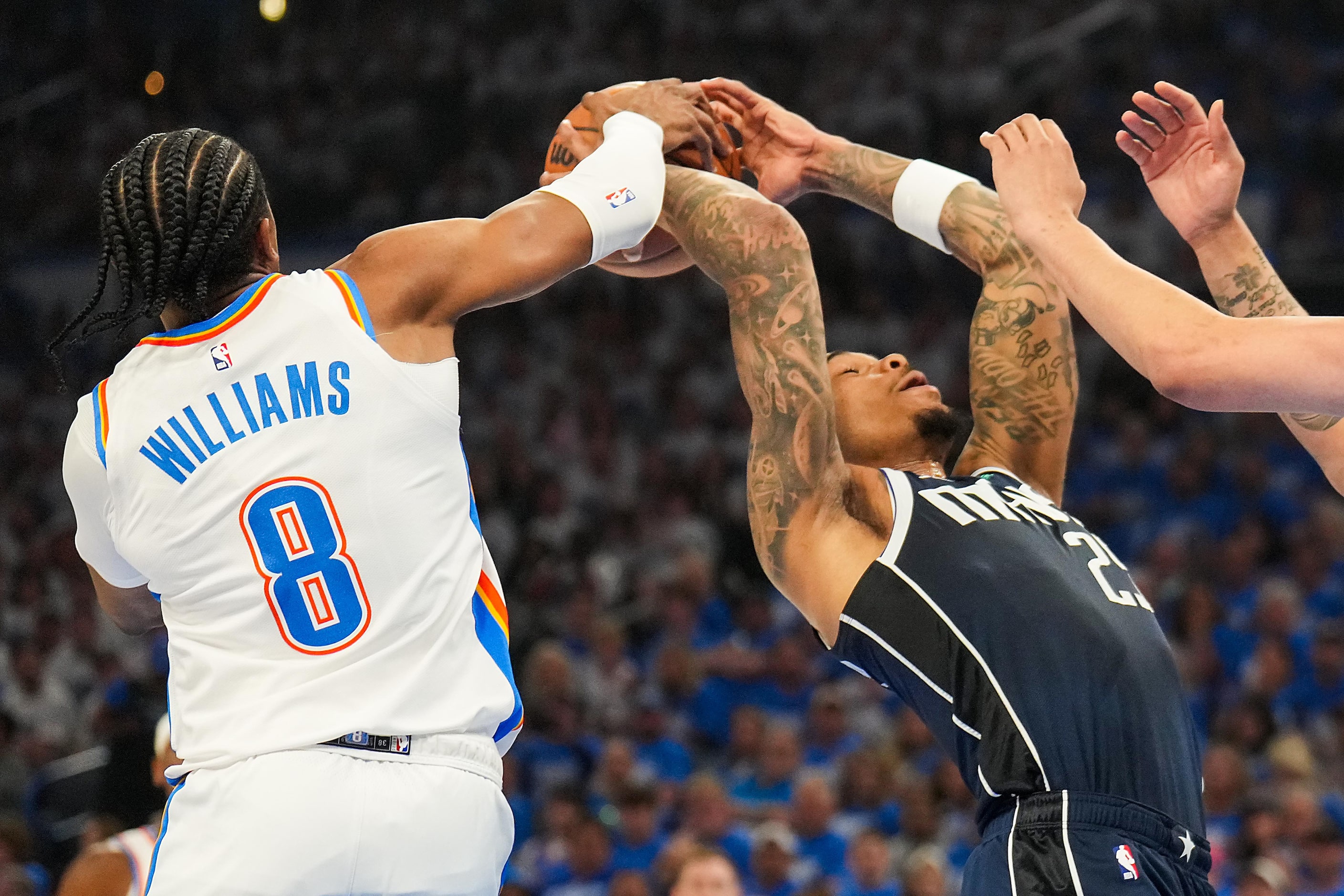 Dallas Mavericks forward P.J. Washington (25) fights for a rebound with Oklahoma City...