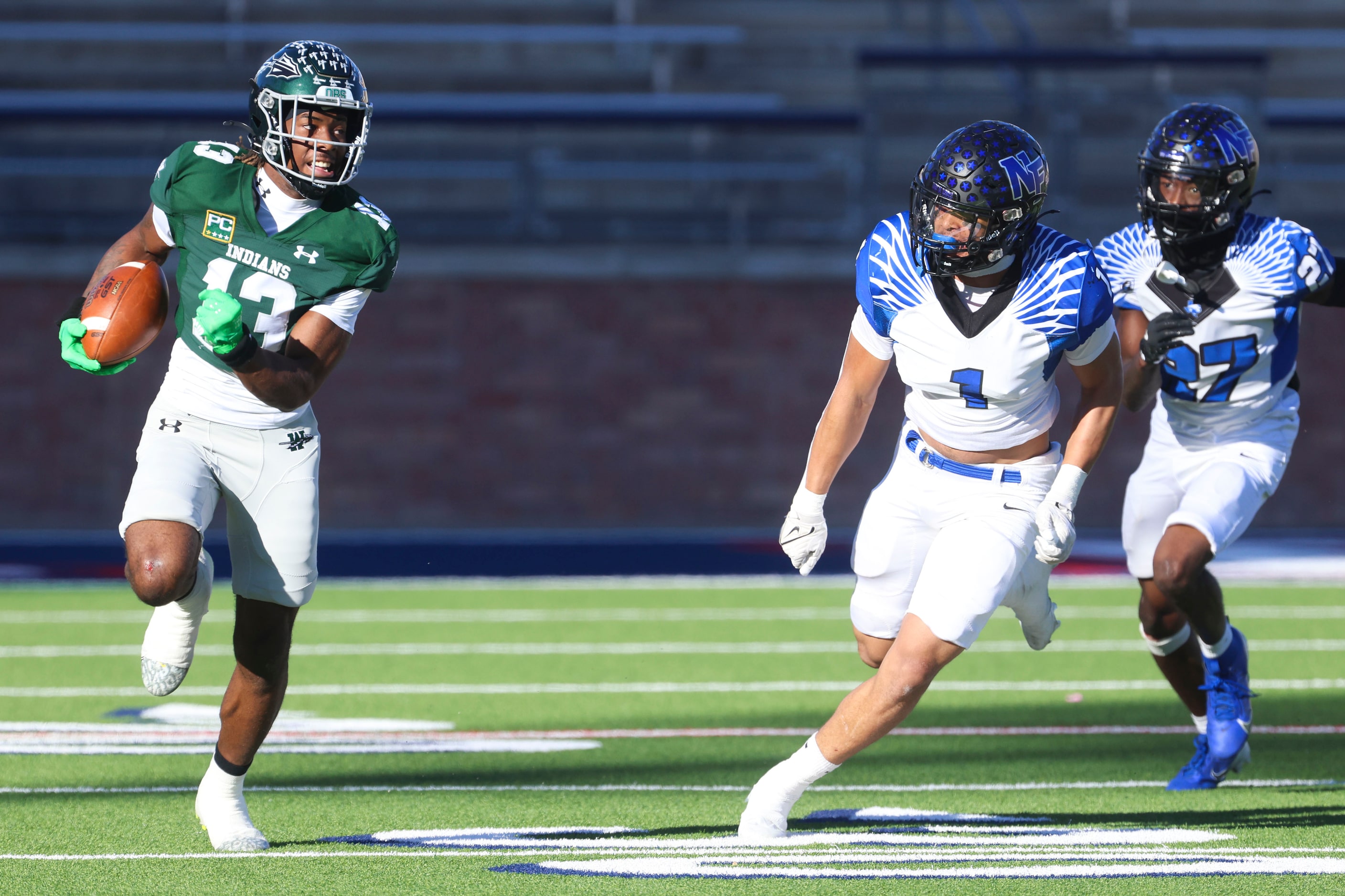 Waxahachie High’s Tristian Gardner (13) runs for a yard gain past North Forney’s Caleb Holt...