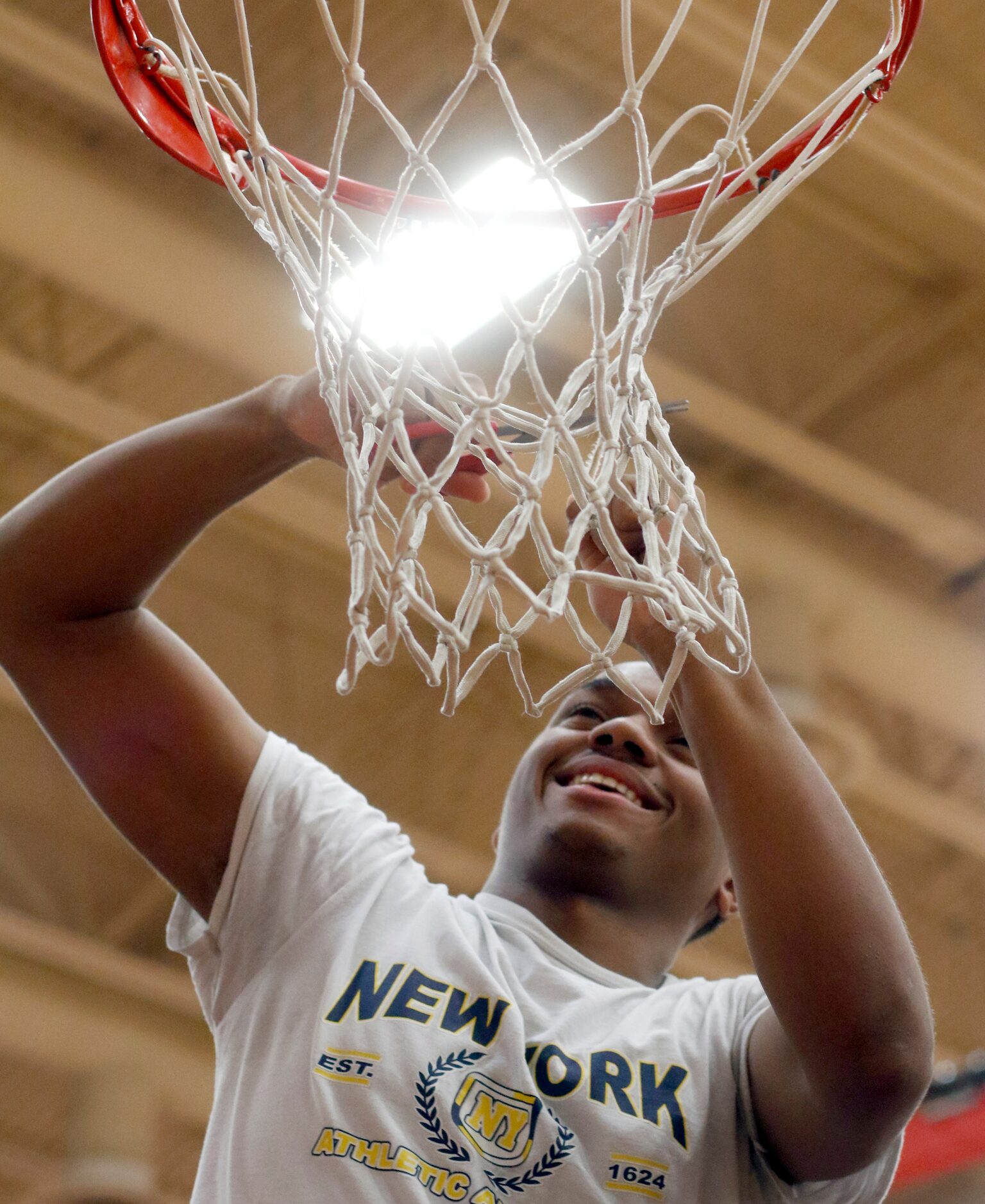 Mesquite Horn's Edwin Pruitt (35) was all smiles as he helps to cut the net down following...