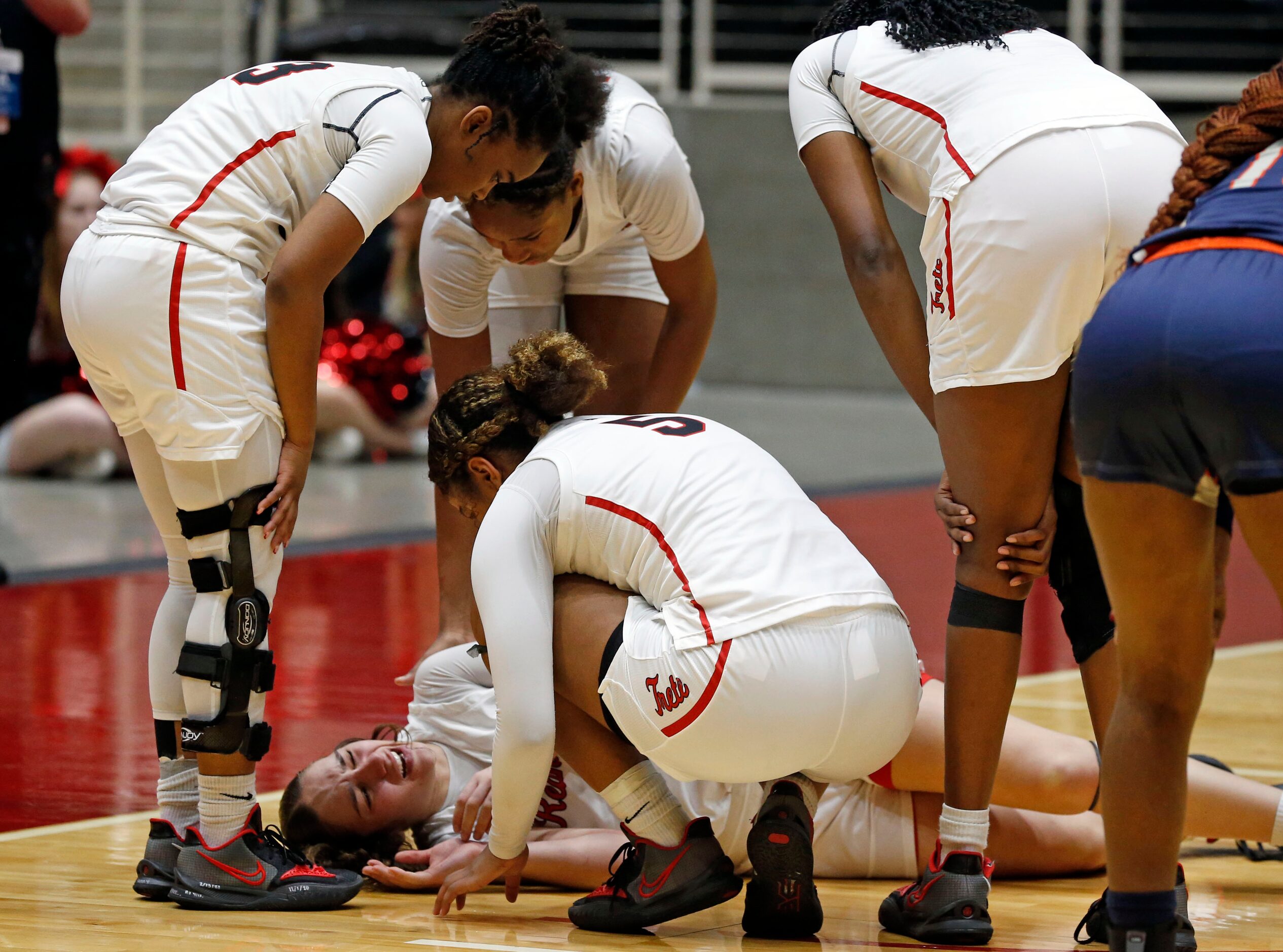 Frisco Liberty High’s G Jezelle Jolie Moreno, on floor, is attended to by teammates, after...