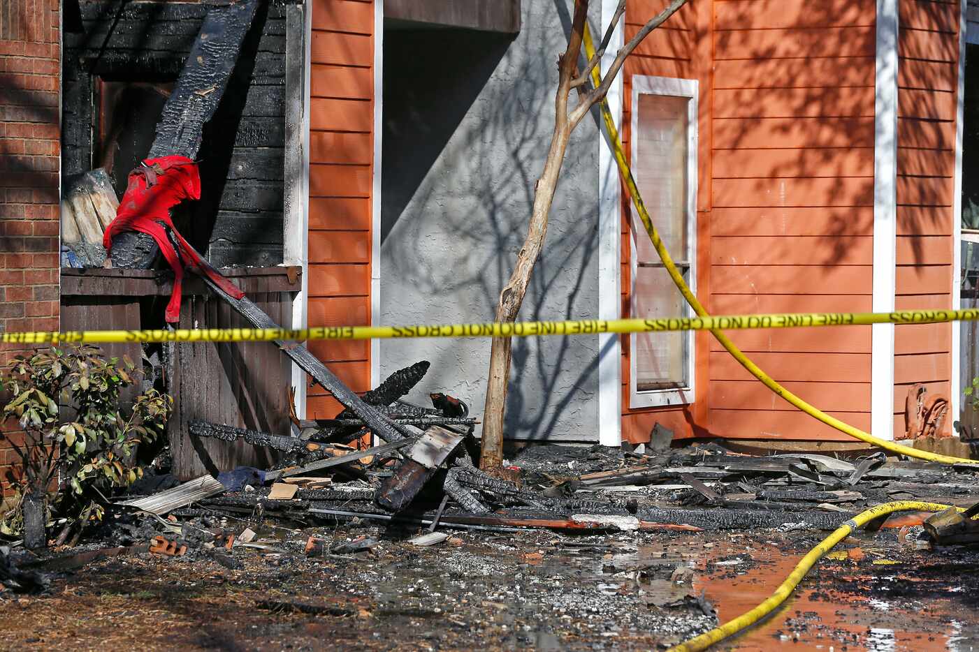 The debris of an apartment complex is seen after Dallas firefighters battle a 4-alarm fire...