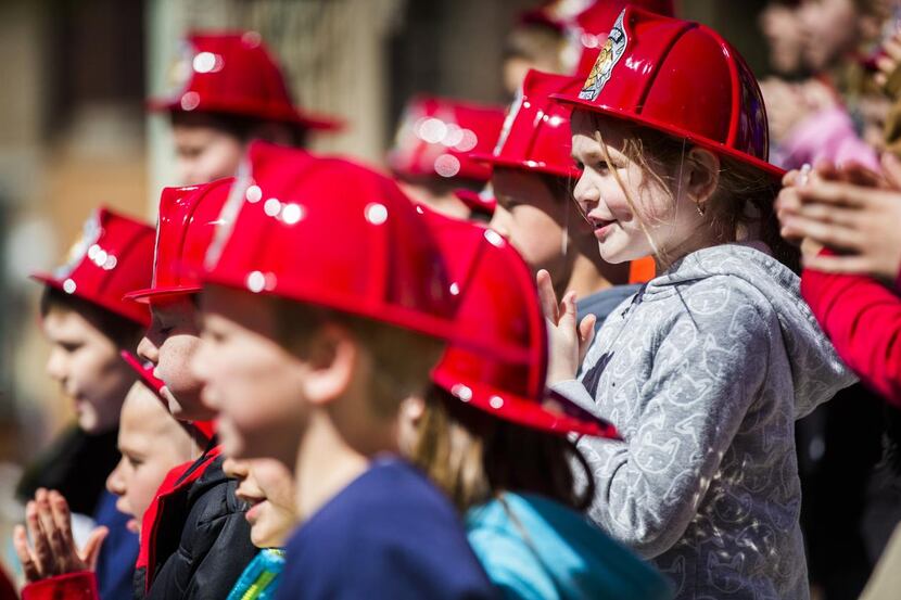 
Members of the North Lamar Second Grade Choir, wearing firefighter hats, lent their voices...