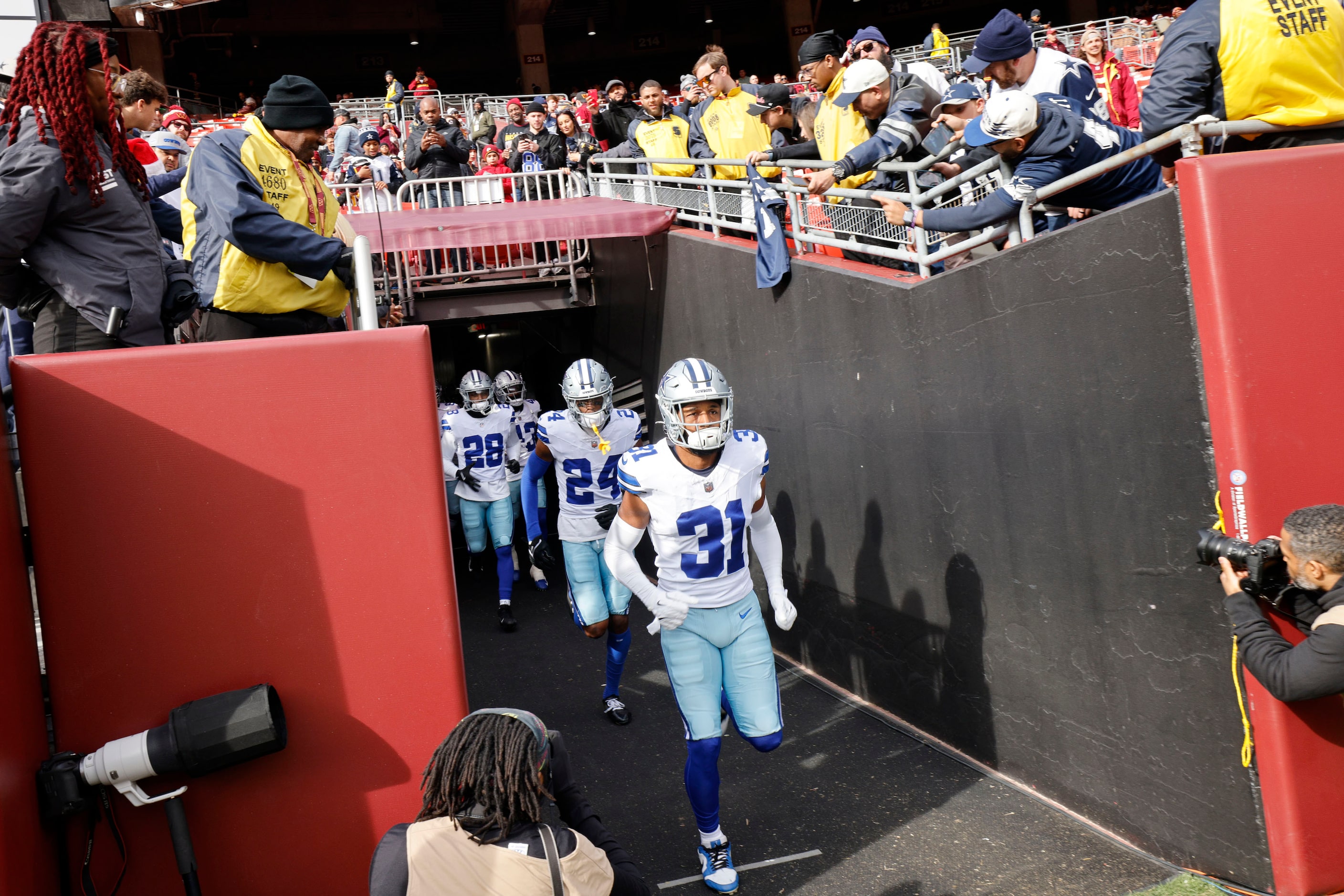 Dallas Cowboys run out to the field before an NFL football game against the Washington...