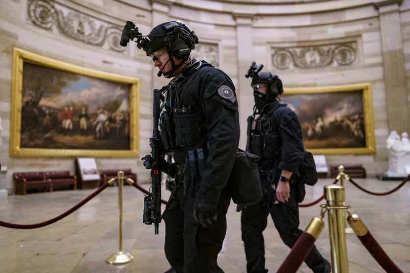 Members of the U.S. Secret Service Counter Assault Team walked through the Capitol Rotunda...
