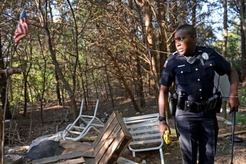 
Garland Neighborhood Police Officer Wendy Sheriff patrols a homeless camp near the 2200...