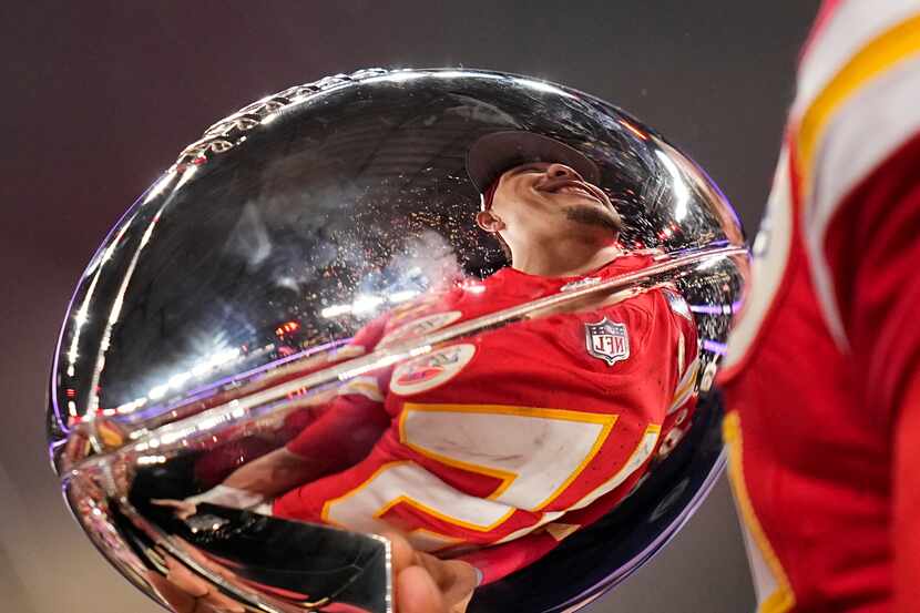 Kansas City Chiefs quarterback Patrick Mahomes is reflected in the Vince Lombardi Trophy...