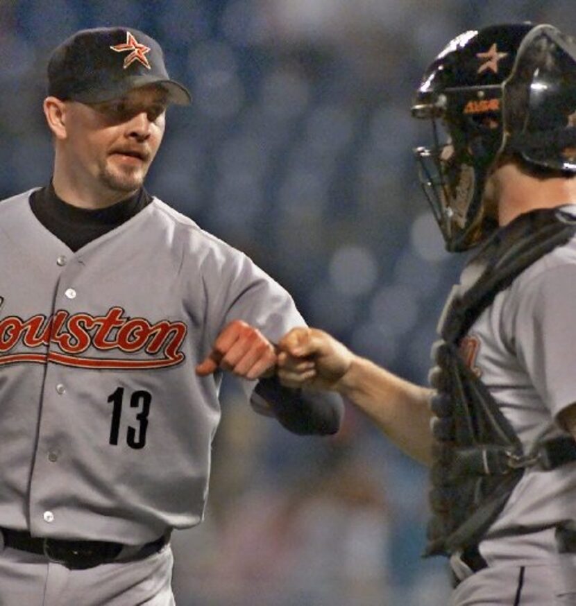 Houston Astros reliever Billy Wagner (13) and catcher Brad Ausmus celebrate the final out by...