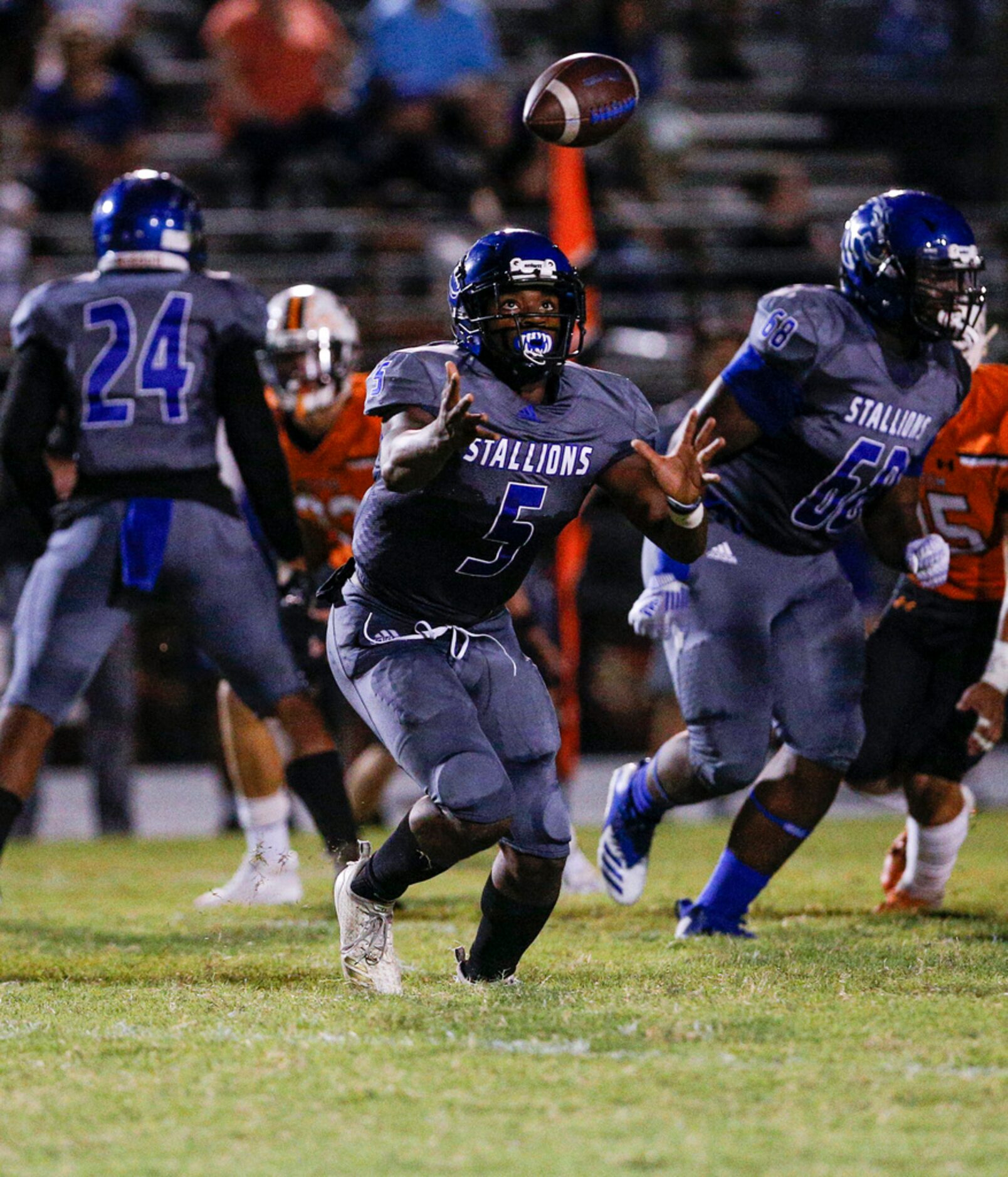 TXHSFB North Mesquite senior quarterback Kamaury Thompson (5) reaches for a bad snap during...