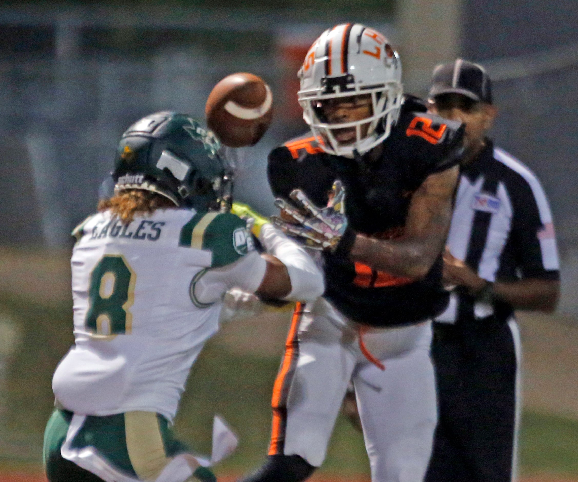 DeSoto High defender Jai Trawick (8) and Lancaster High’s Sir’Eric Scarbrough (12) fight for...