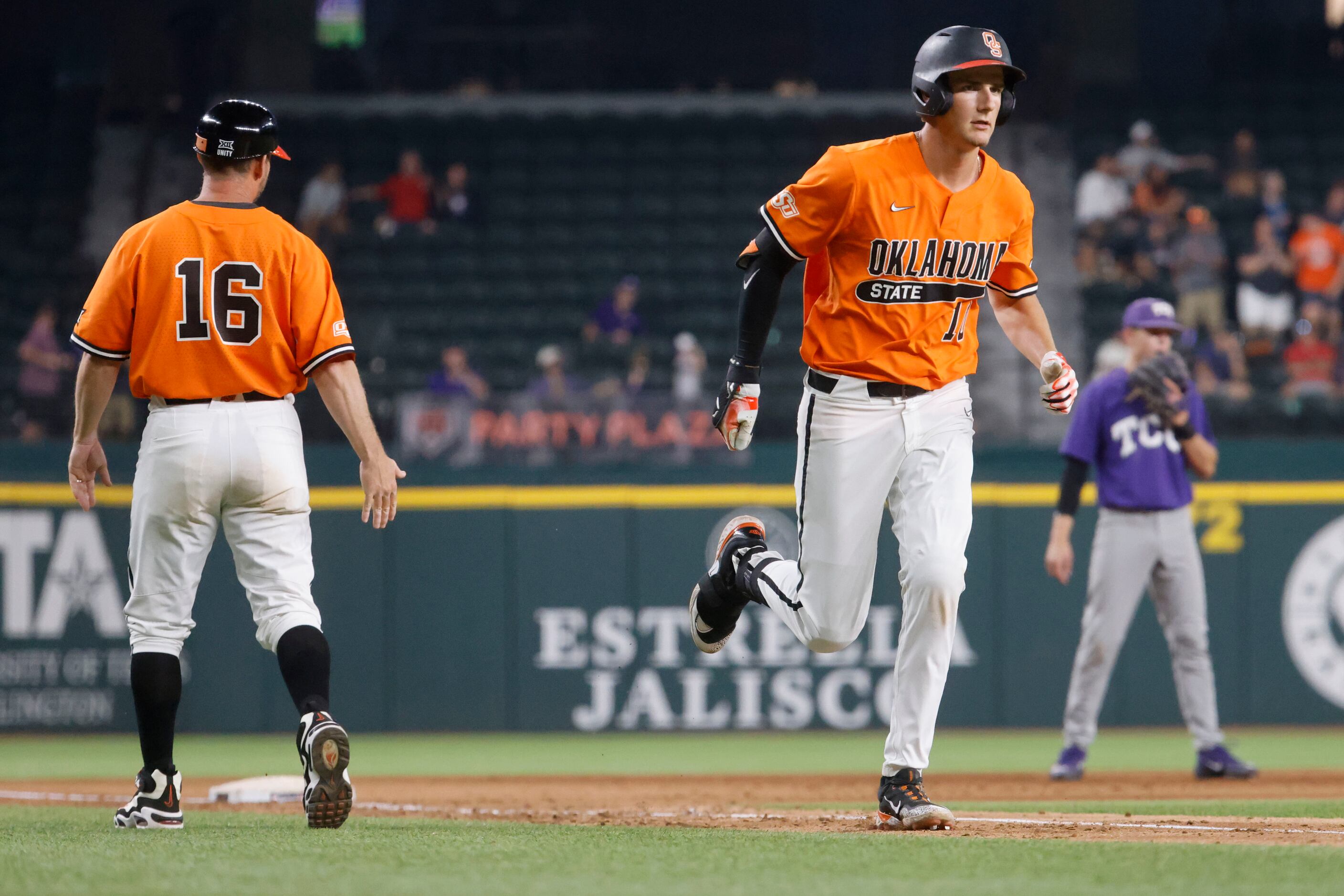 Oklahoma St. outfielder Nolan Schubart progresses to the home plate after hitting a homer...