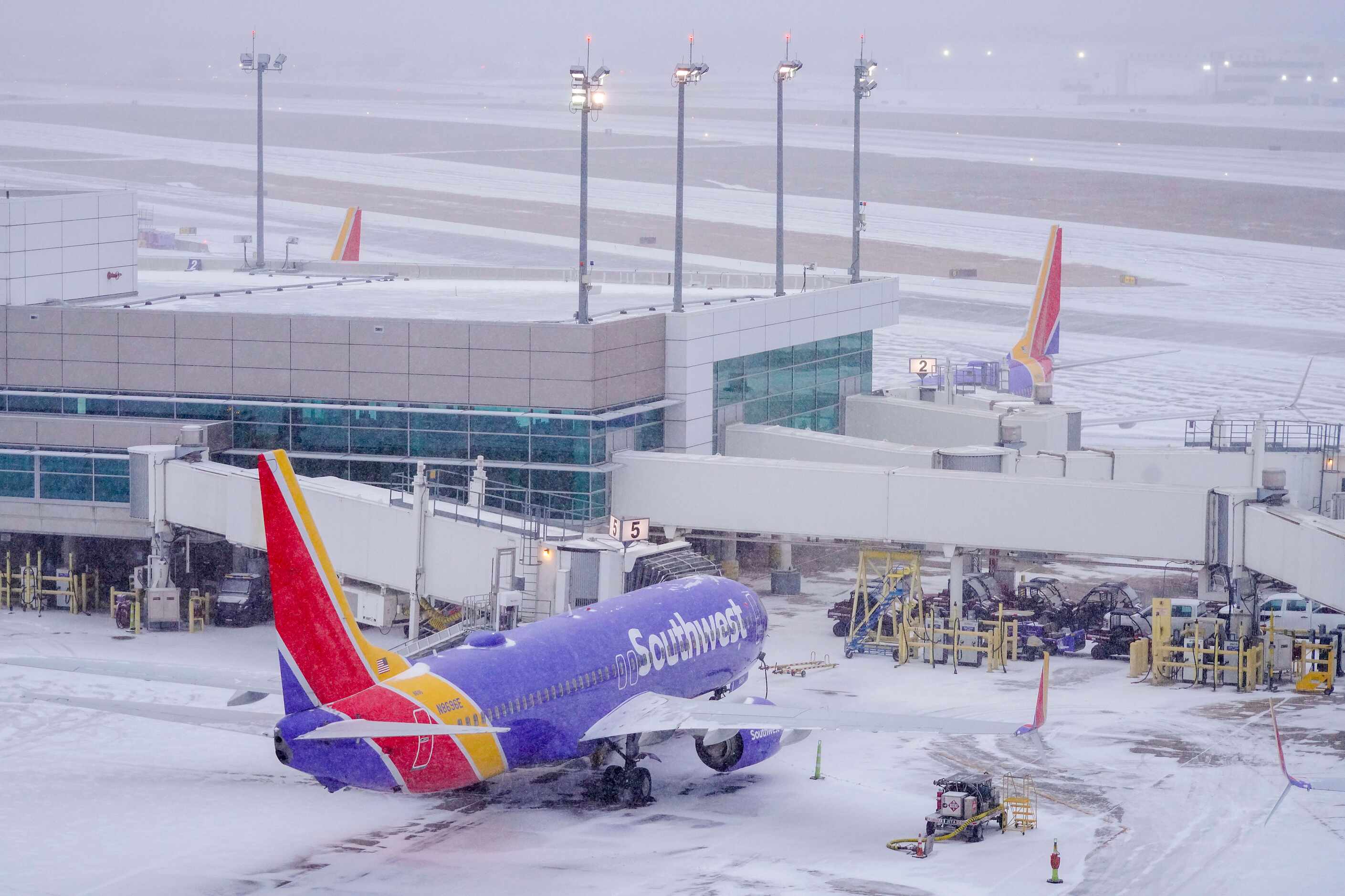 Idle Southwest Airlines planes sits at gates at Dallas Love Field as a winter storm brings...