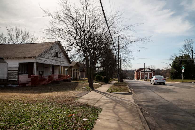 An abandoned home, left, and the Greater El Bethel Missionary Baptist Church, far-right in...