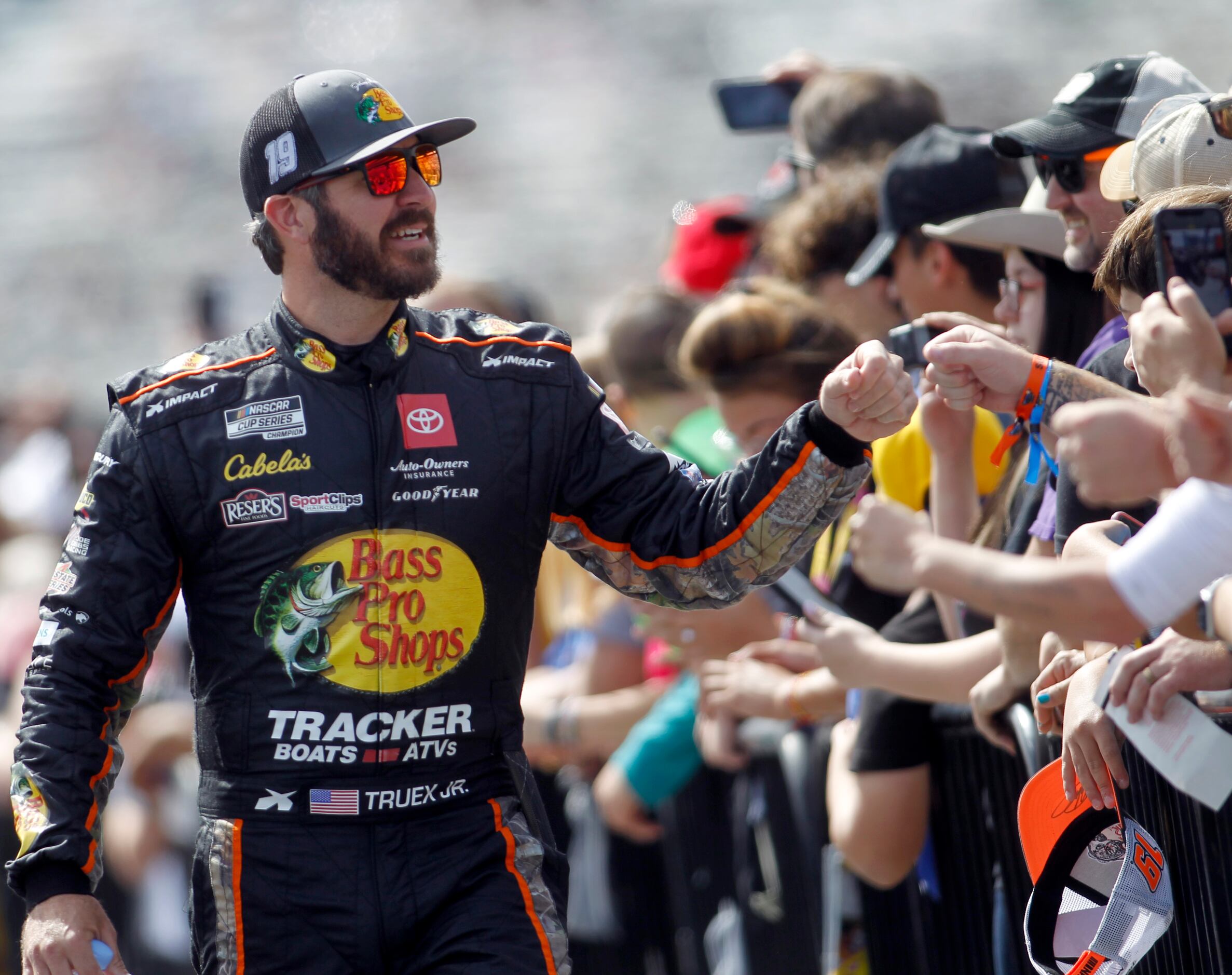 Driver Martin Truex, Jr. greets race fans during driver introductions prior to the start of...