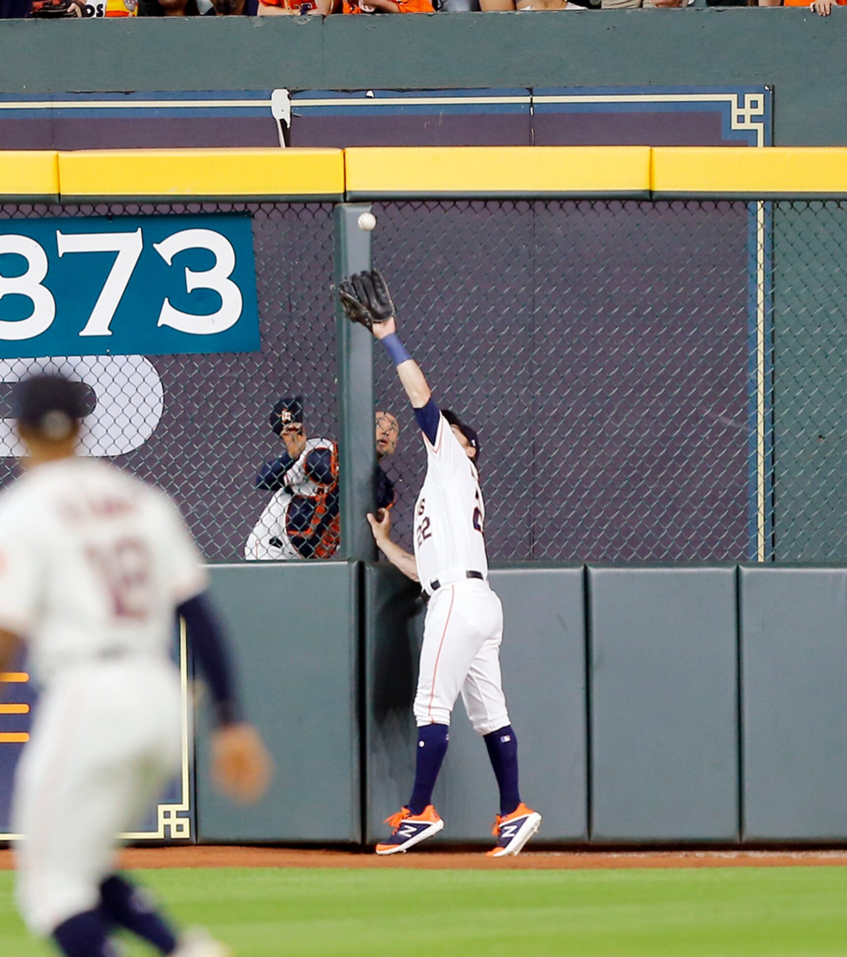 HOUSTON, TEXAS - JULY 20: Josh Reddick #22 of the Houston Astros makes a catch at the wall...