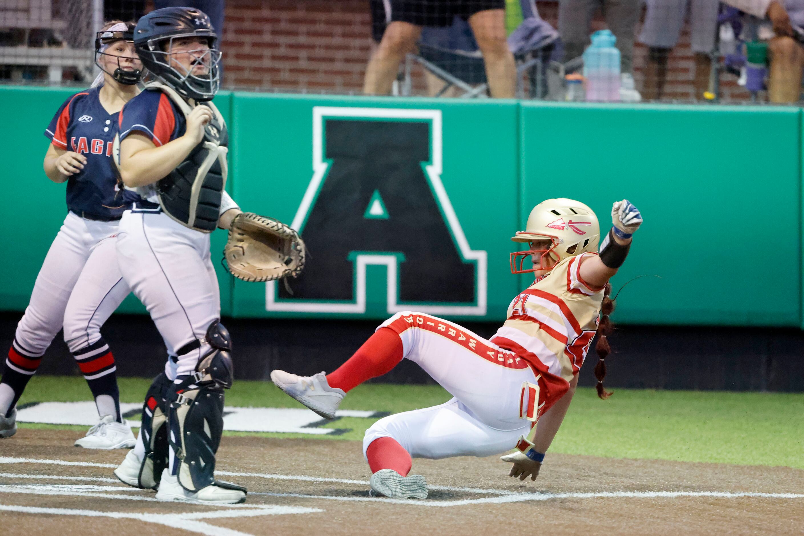 South Grand Prairies’ Adriana Mountcastle scores in front of Allen Catcher Taylor Wright,...