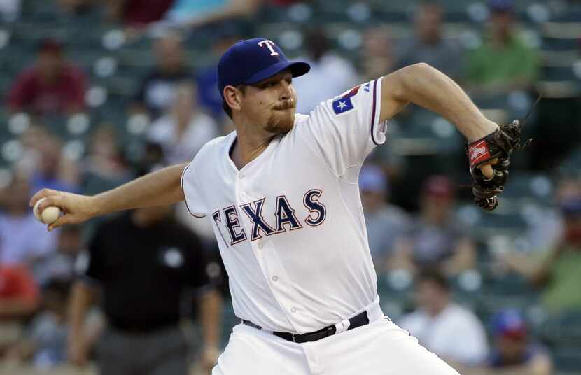 Texas Rangers starting pitcher Nick Tepesch winds up to deliver to the Texas Rangers in the...