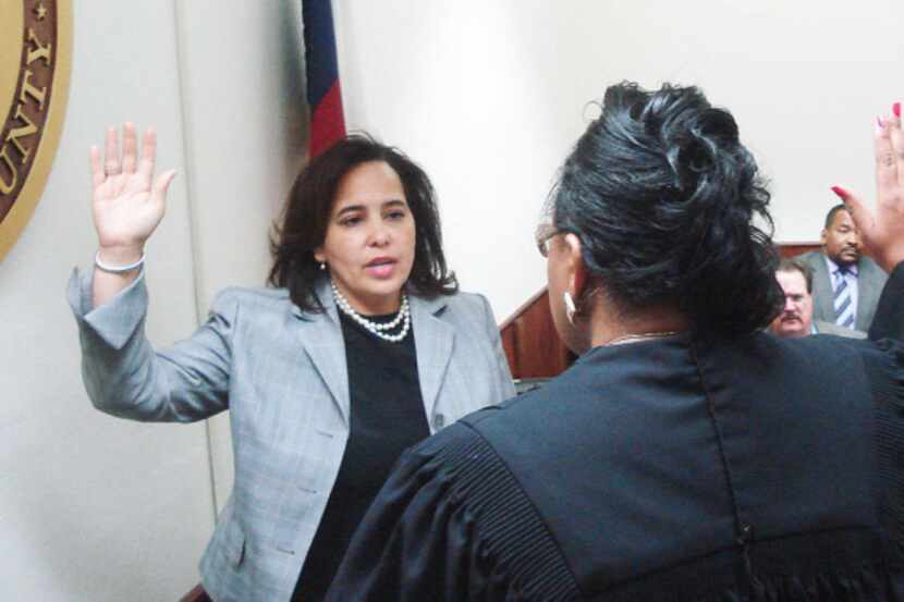 Erleigh Norville Wiley (left) was sworn in as Kaufman County district attorney Monday by...
