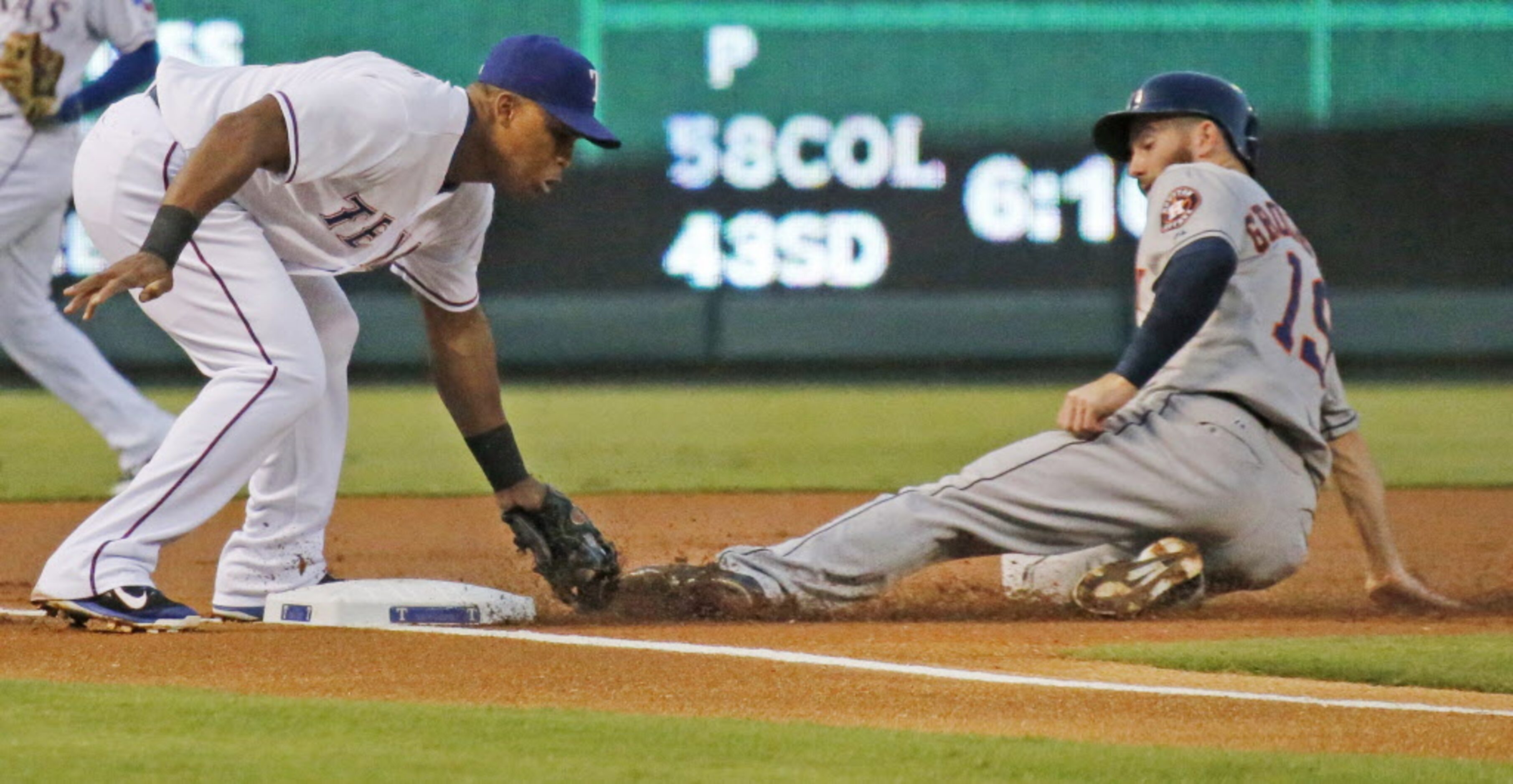 Houston's Robbie Grossman is out at third as Texas third baseman Adrian Beltre makes the tag...