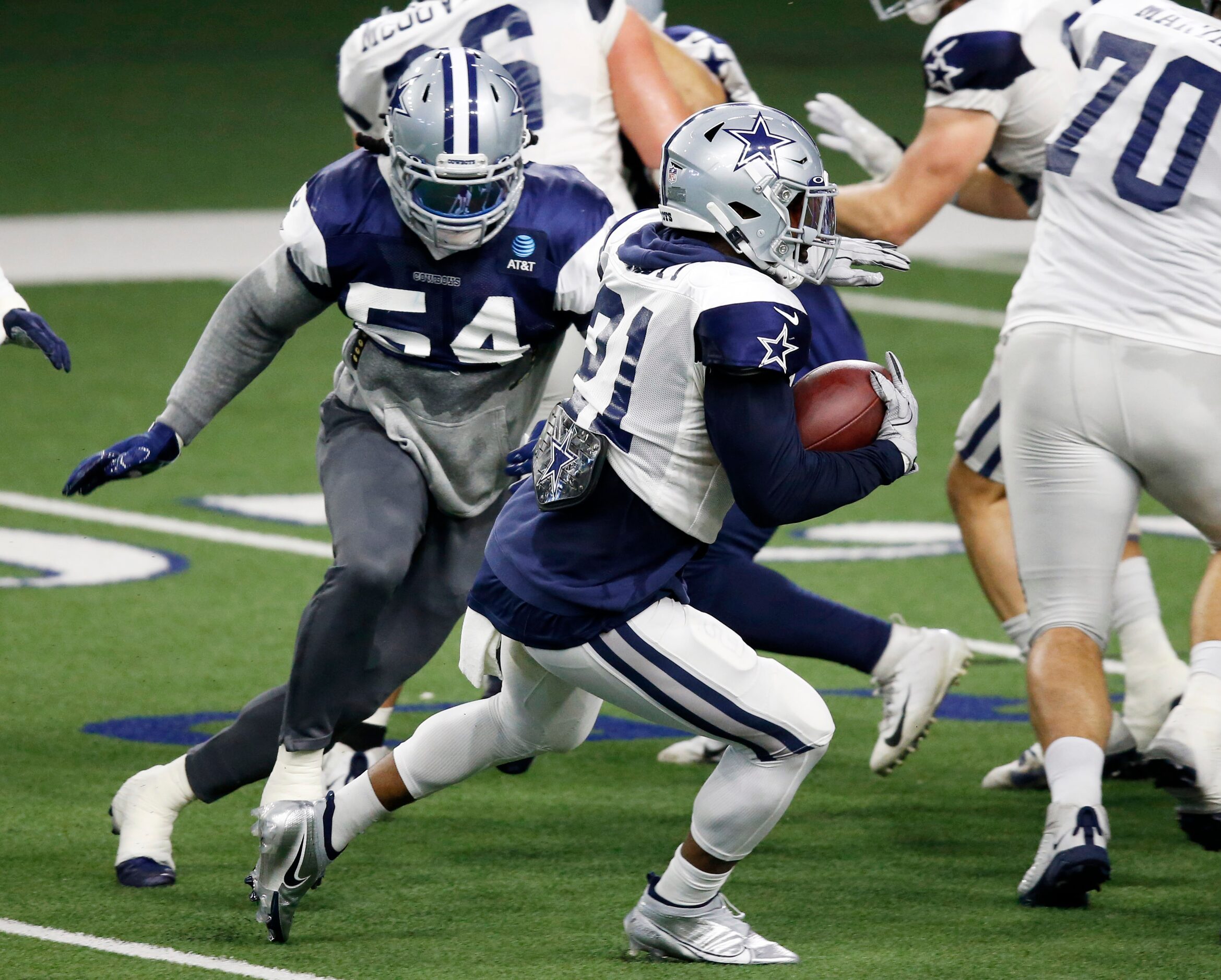 Dallas Cowboys linebacker Jaylon Smith (54) closes in on Dallas Cowboys running back Ezekiel...