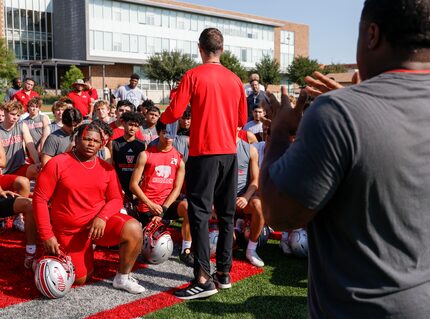 Arnaz Reese watches deaf education interpreter Ashley Anderson while head coach John Fish...