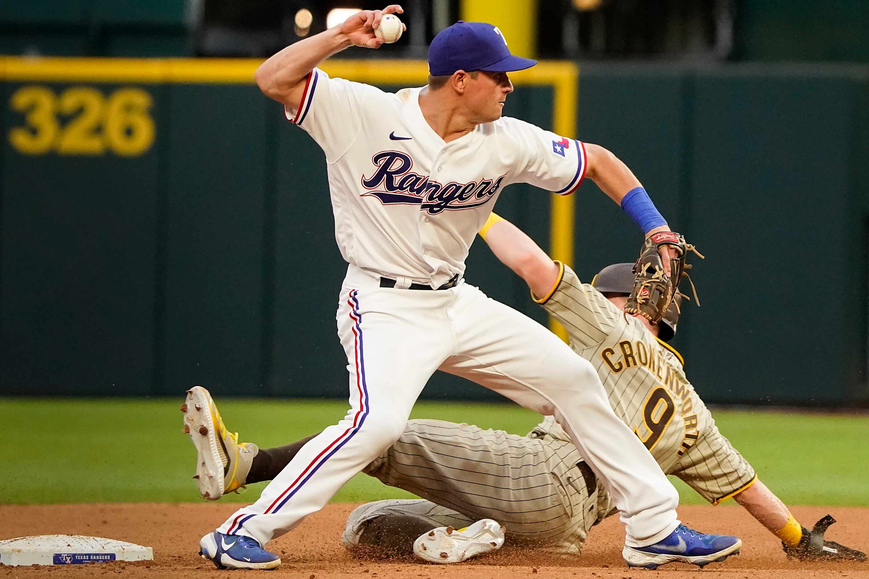 Texas Rangers second baseman Nick Solak turns a double play over San Diego Padres second...